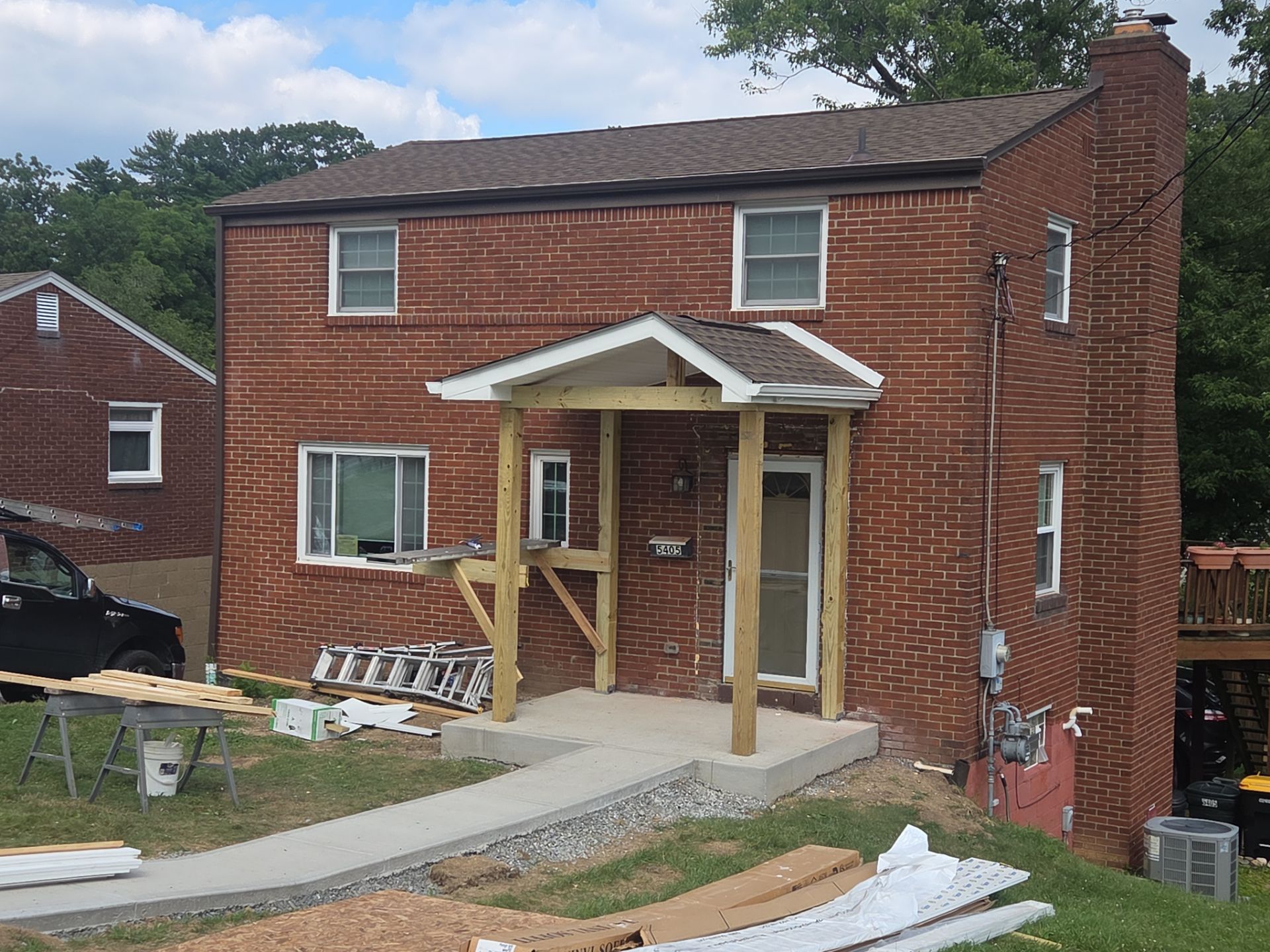 Concret and roof build  by Cousins Roofing Siding & Decks