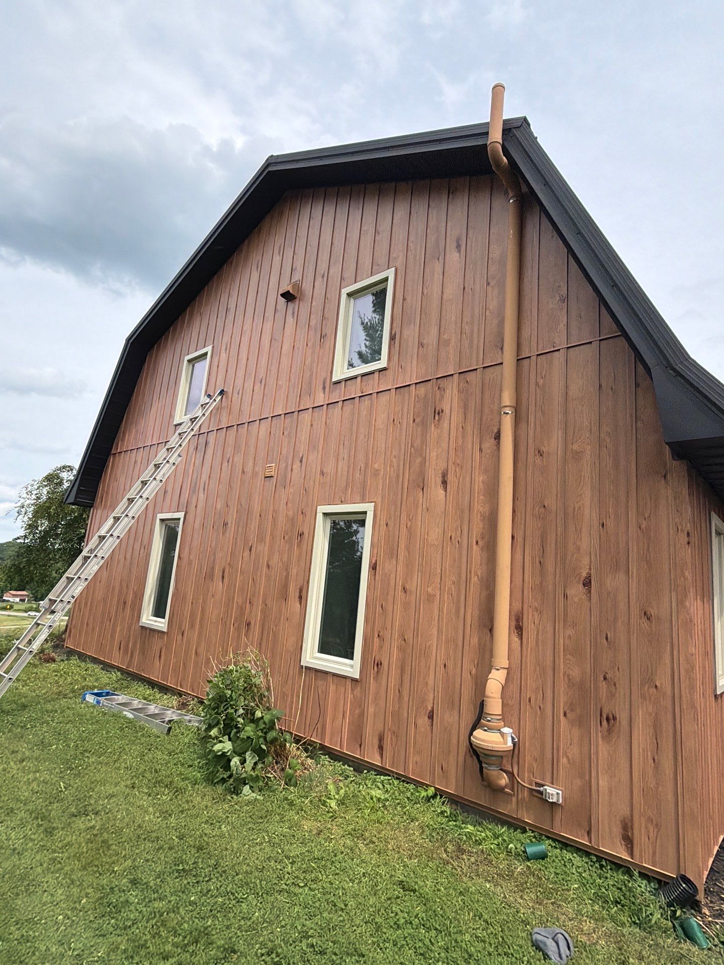 Complete Exterior Transformation with Textured Black Metal Roofing and Hickory Board-and-Batten Siding in Hebron by BZ Exteriors