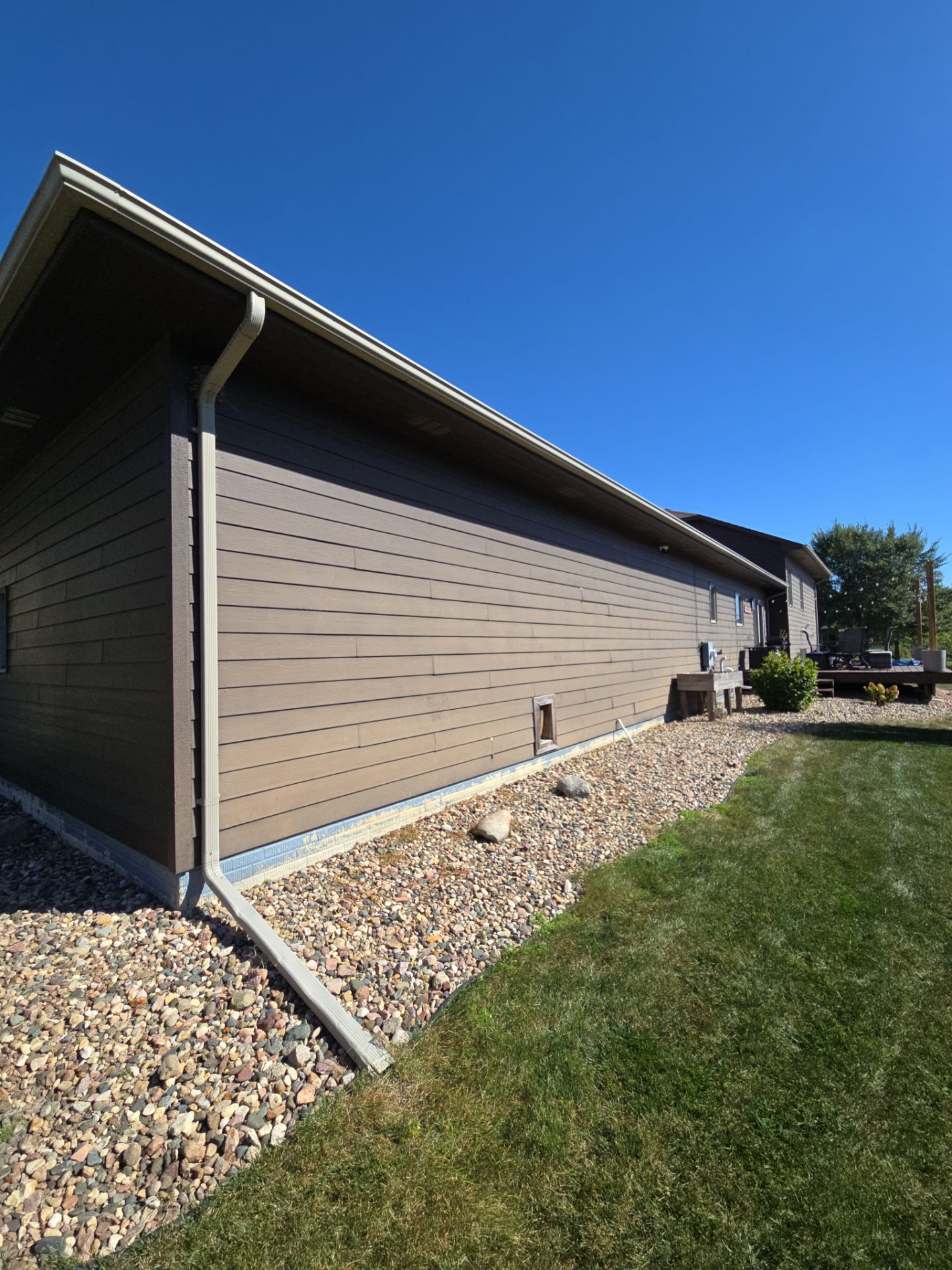 Dark Blue Exterior Home Painting and Siding Refresh in Sioux Falls by Select Painting, Coatings & Garage Cabinets