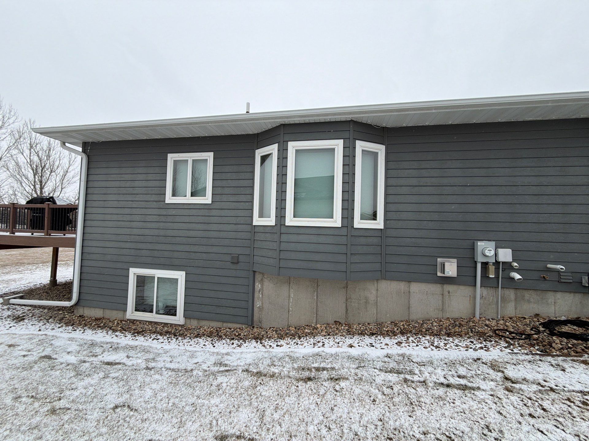 Madison Exterior Remodel with Dark Gray Siding and Stone Accents by Select Painting, Coatings & Garage Cabinets