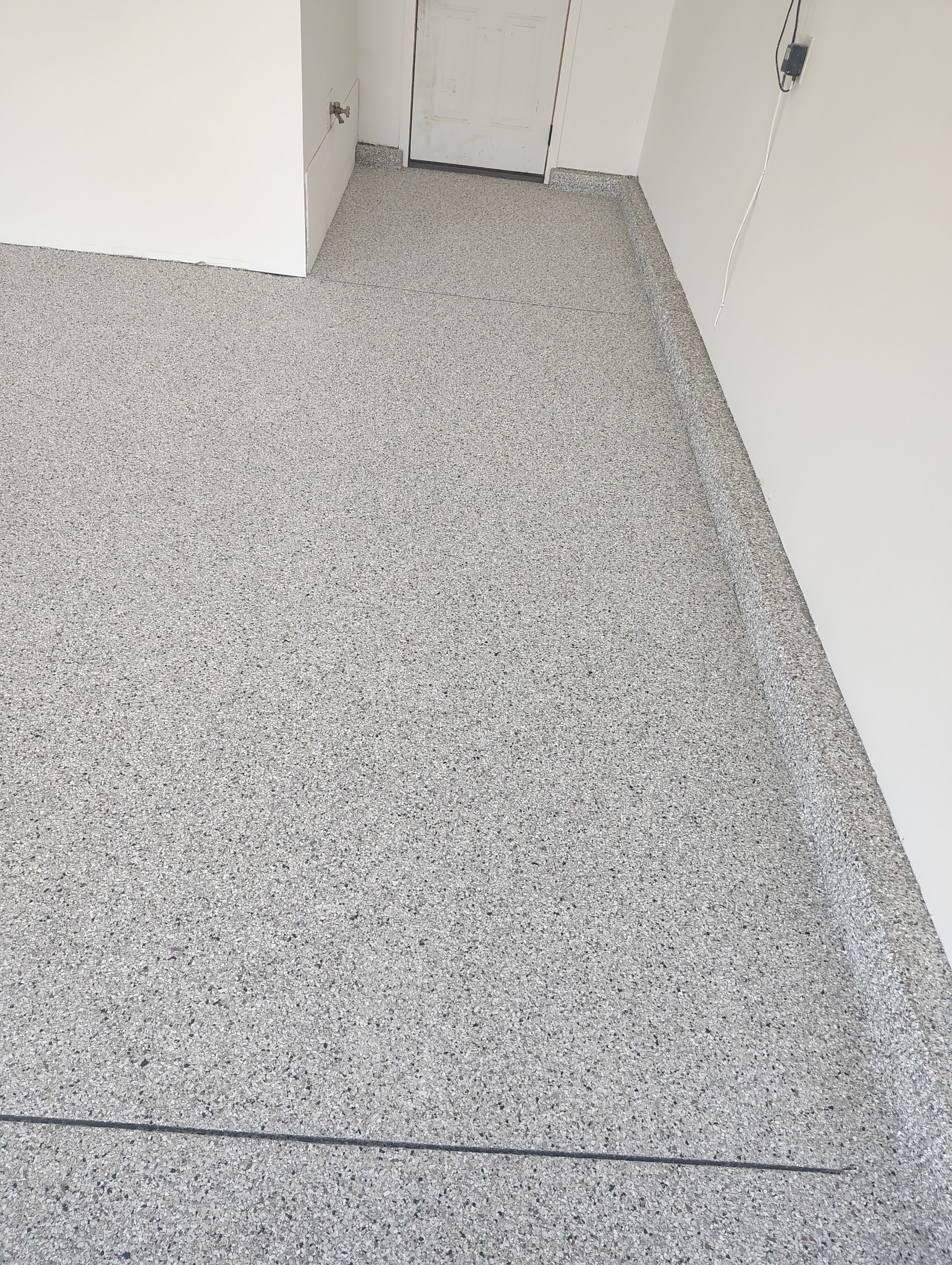 Custom Grey Speckled Epoxy Floor Coating for Sioux Falls Garage by Select Painting, Coatings & Garage Cabinets