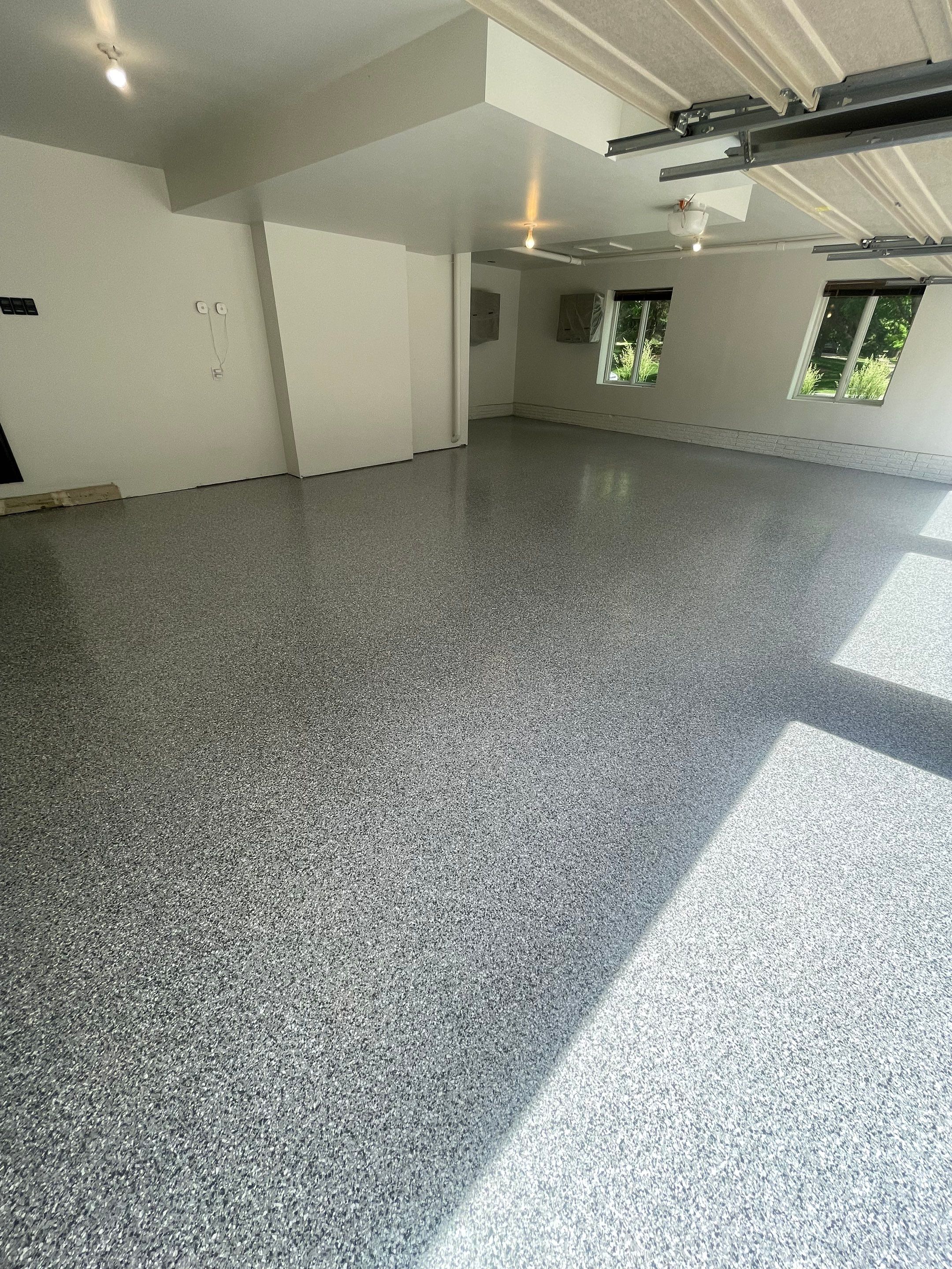 Gray Speckled Epoxy Garage Floor Coating in Sioux Falls by Select Painting, Coatings & Garage Cabinets