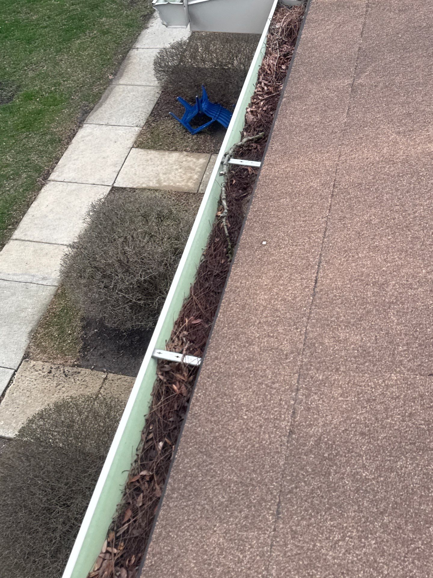 Commercial gutter cleaning Naperville & Aurora, IL before photo with filled gutters