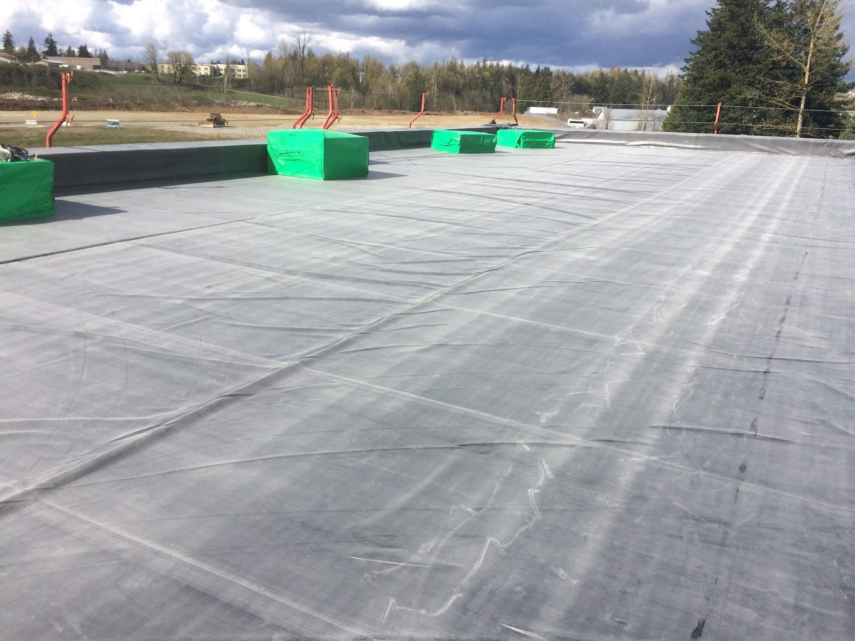 Commercial Roofing Installation using EPDM loose lay with balast by Top Notch Roofing Inc