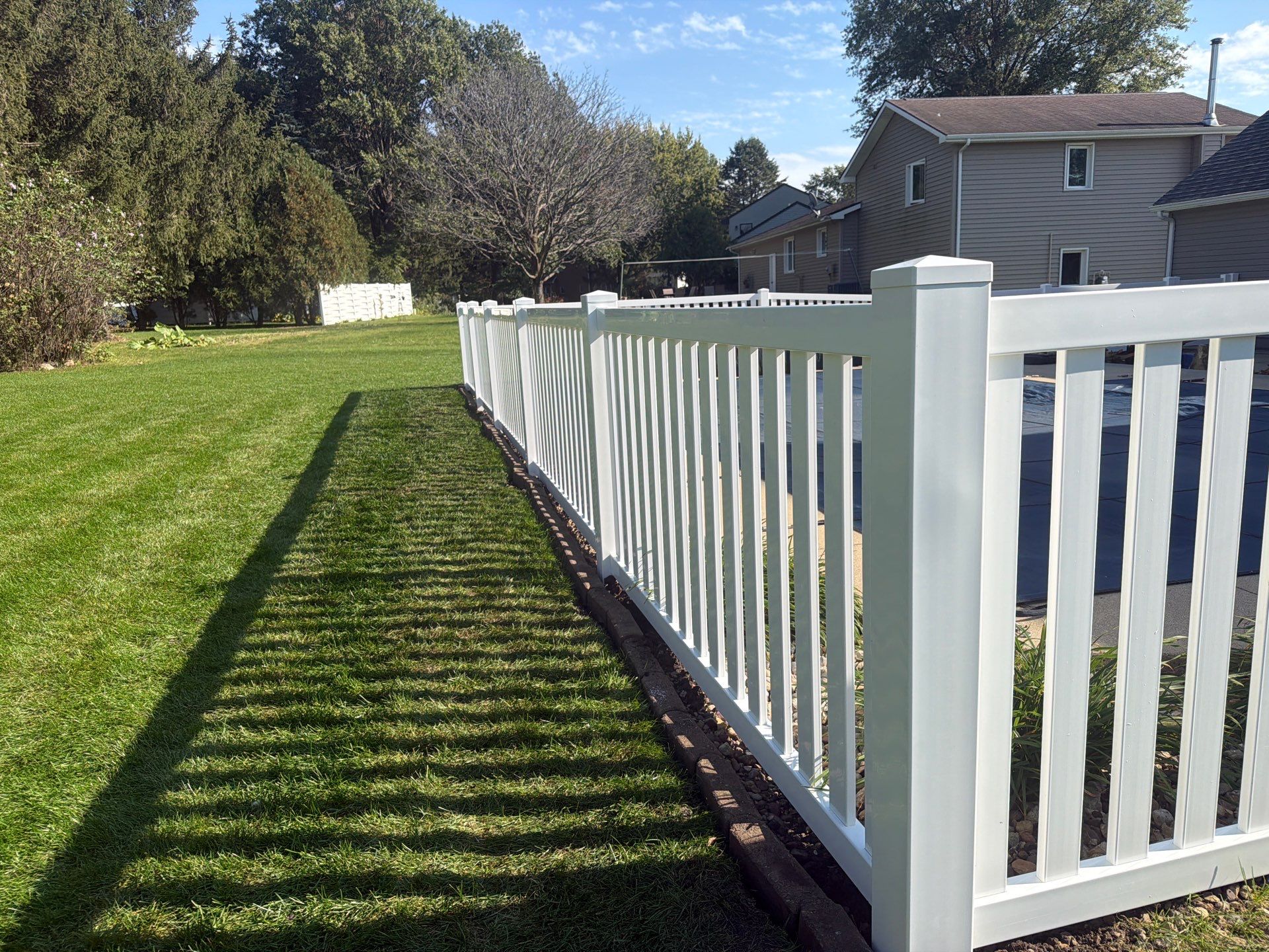 White Vinyl Picket Pool Fence Installation in Waterloo, Iowa by Perfect Picket Fence and Stain
