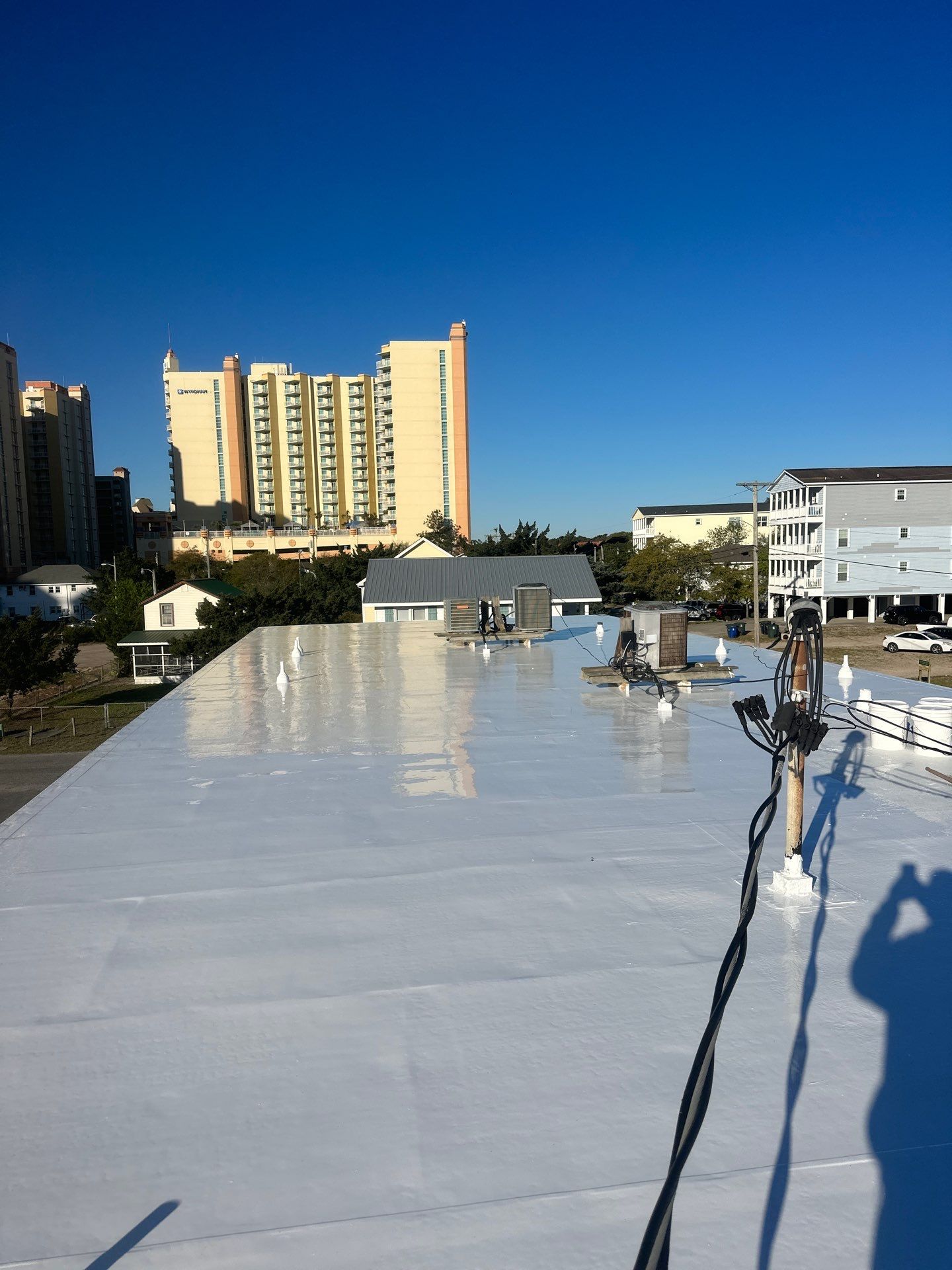 Commercial Building Roof Coating using 924 Eterna-Sil Premium Silicone Roof Coating by RGR Construction and Roofing, LLC