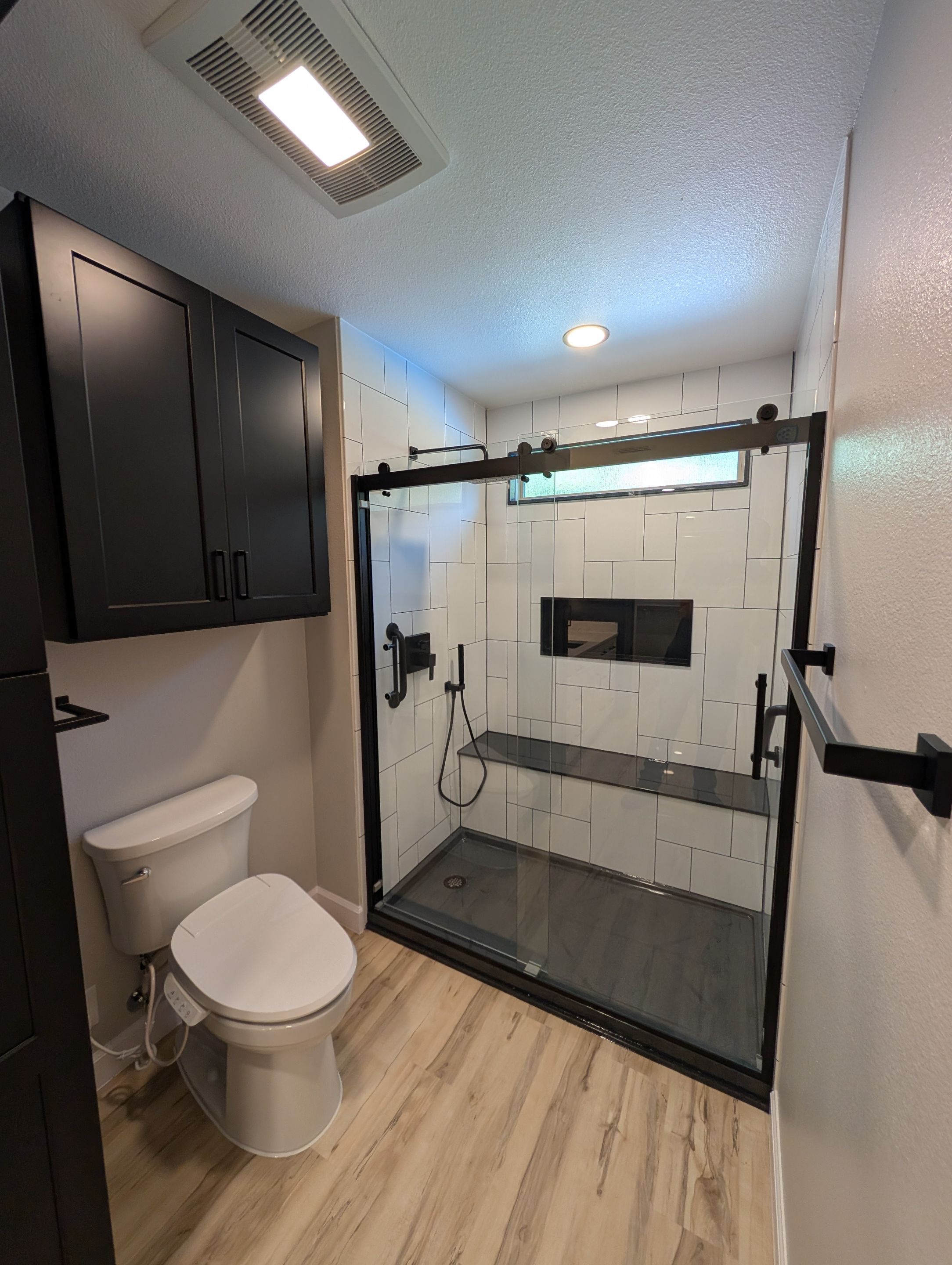 Universal City Tub-to-Shower Conversion with Built-In Bench and Backlit Mirror by Legacy Bath and Kitchen