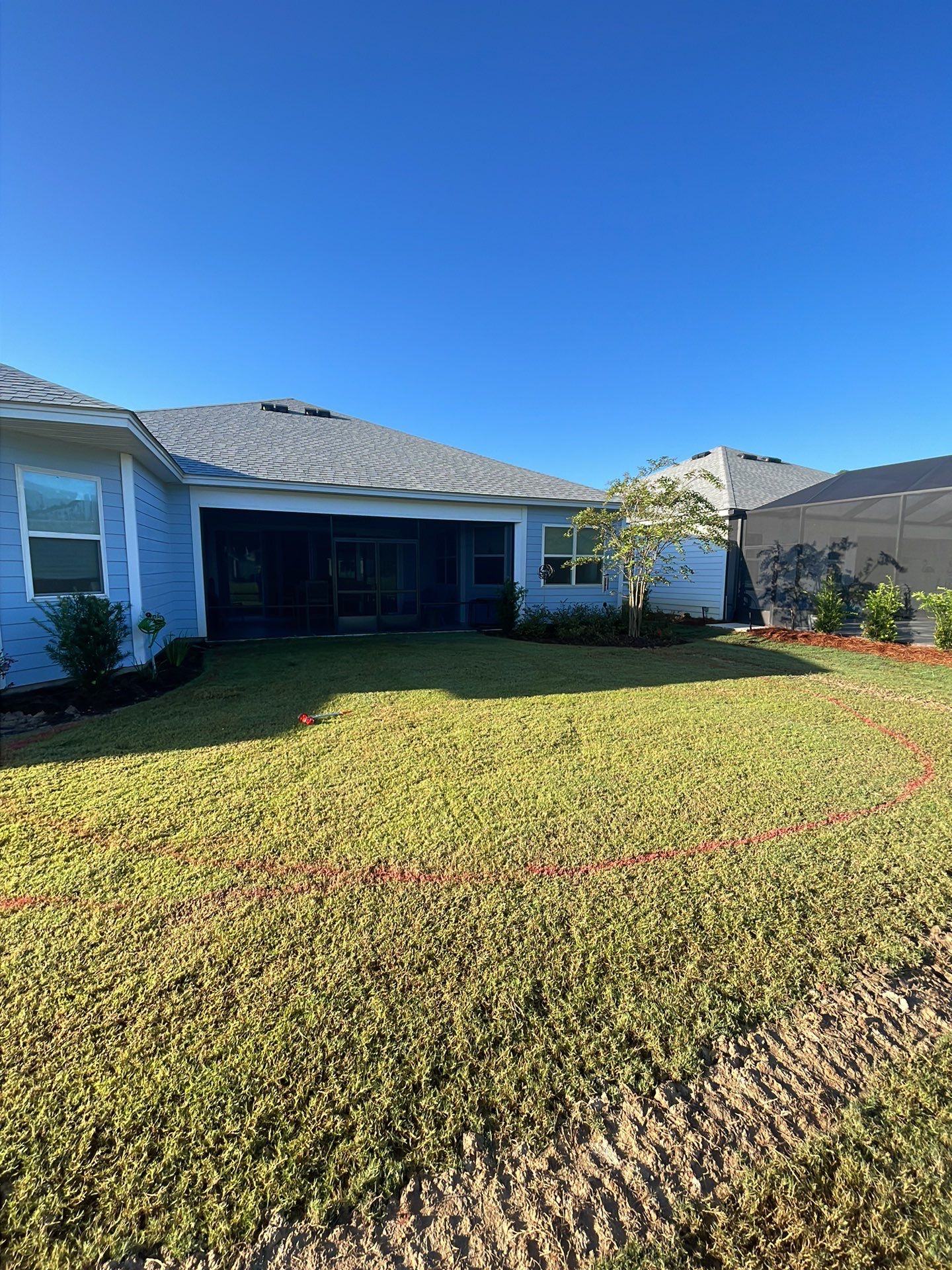 Custom Curved Concrete Patio and Paver Border in Hardeeville by Lowcountry Scapes, LLC