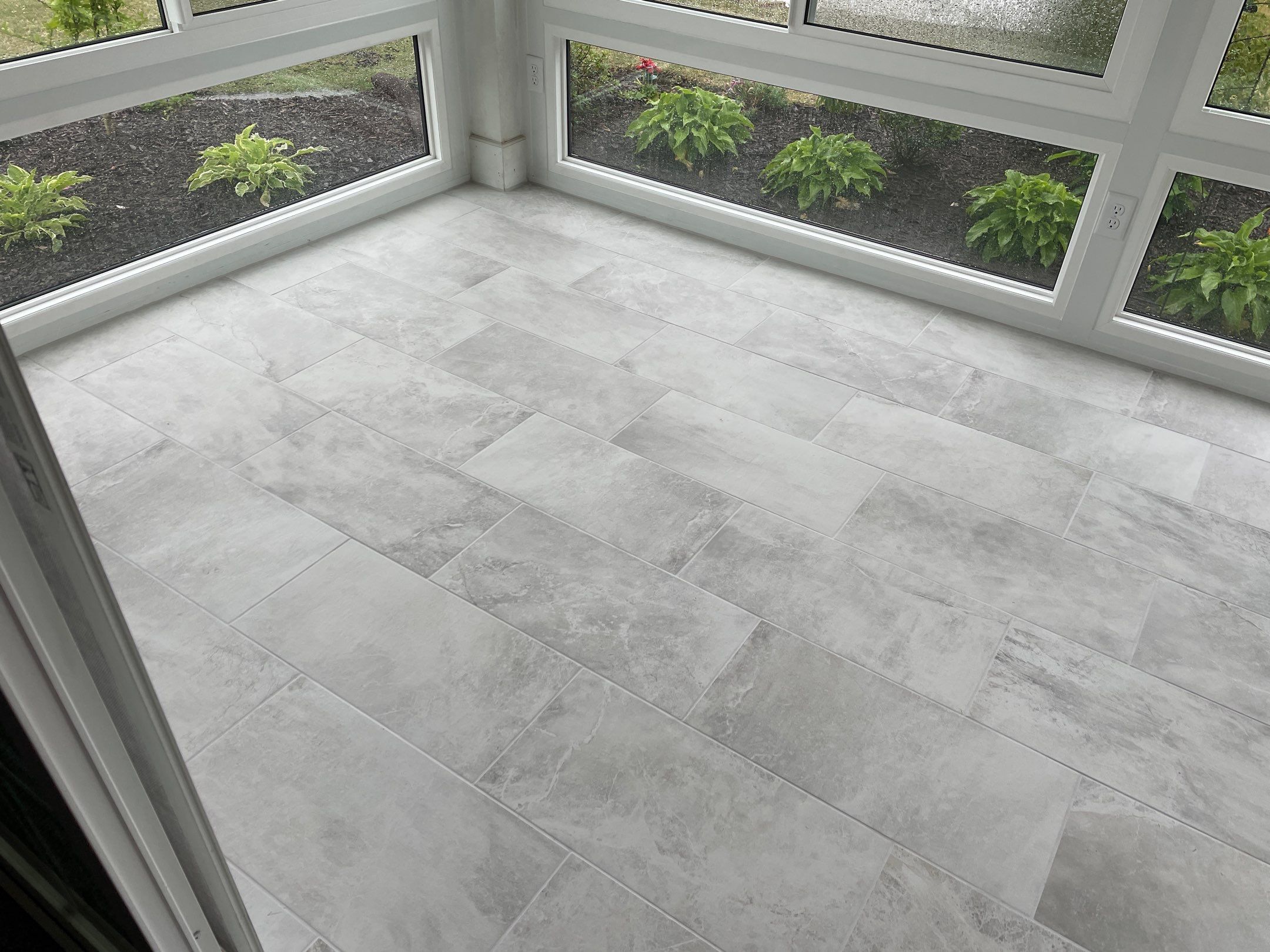 Amazing Tile Transformation After Enclosed Windows Added to Sunroom by Footprints Floors of Coastal Carolina