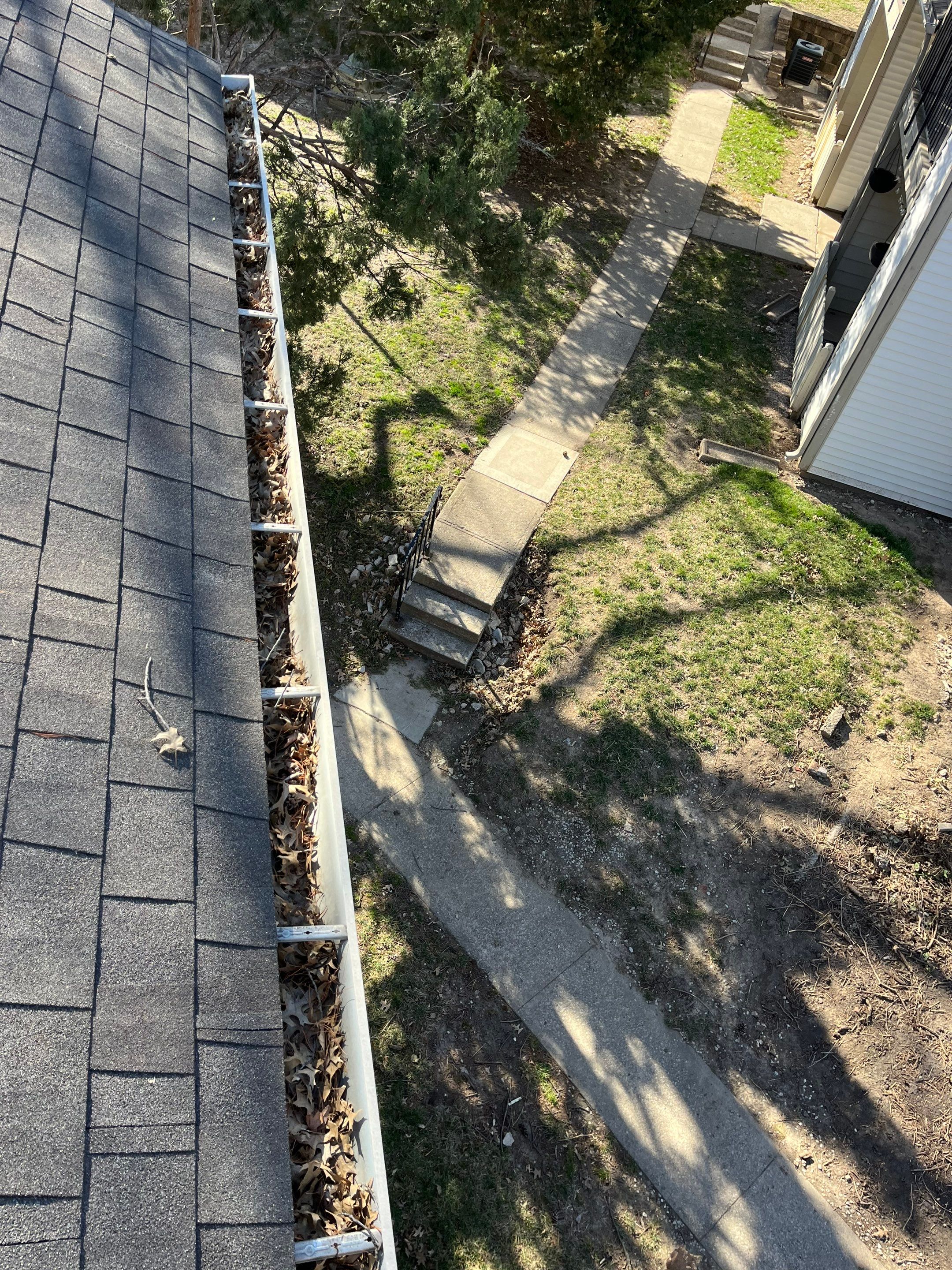 Commercial gutter cleaning Columbia, MO before photo with filled gutters