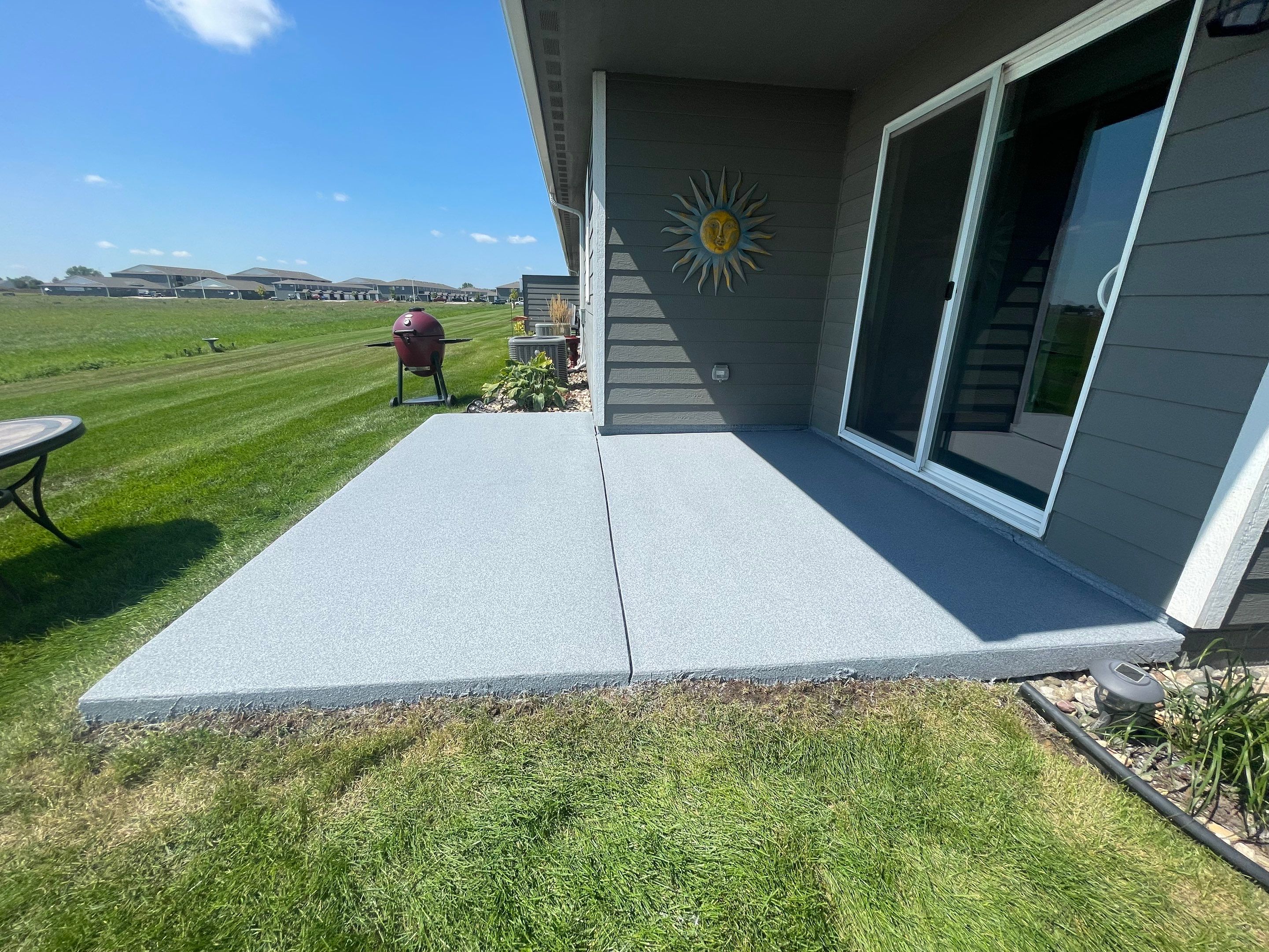 Starry Evening Concrete Patio Coating Installation in Tea by Select Painting, Coatings & Garage Cabinets