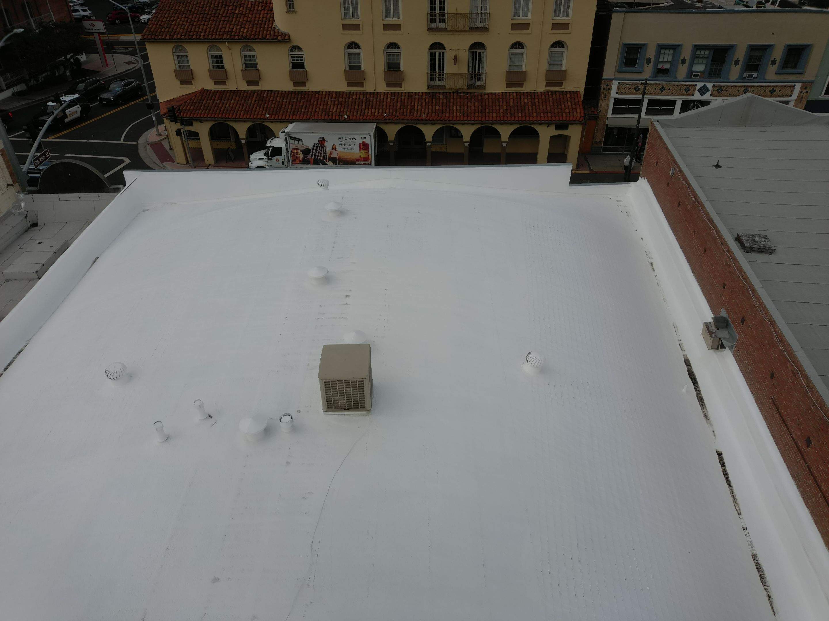 Foam and coatings on commercial roof by Straight Edge Roofing Inc