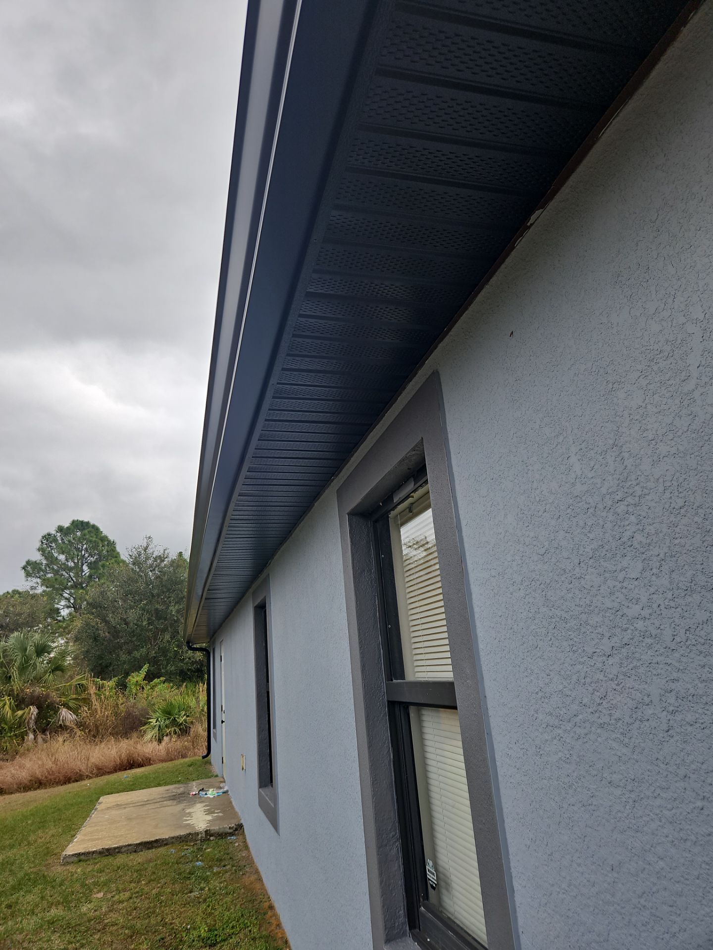 Black Seamless Gutters & Soffit/Fascia in Lehigh Acres FL by Gutter Professors