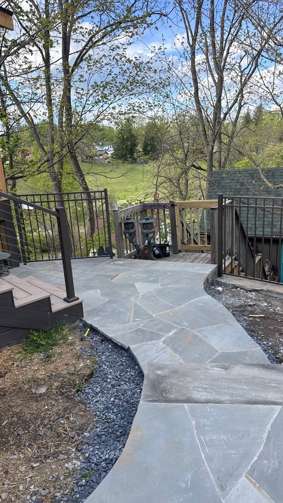 Custom Composite Deck with Stone Fireplace and Modern Cable Railing by Walnut Hollow Decks & Outdoor Living