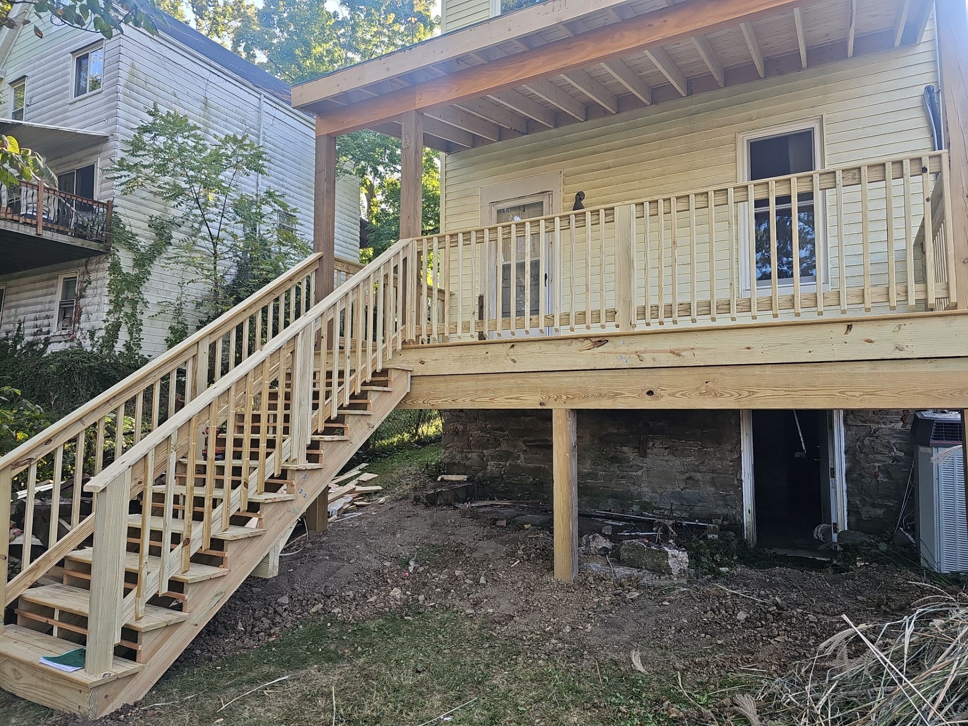 Deck and shed roof by Cousins Roofing Siding & Decks