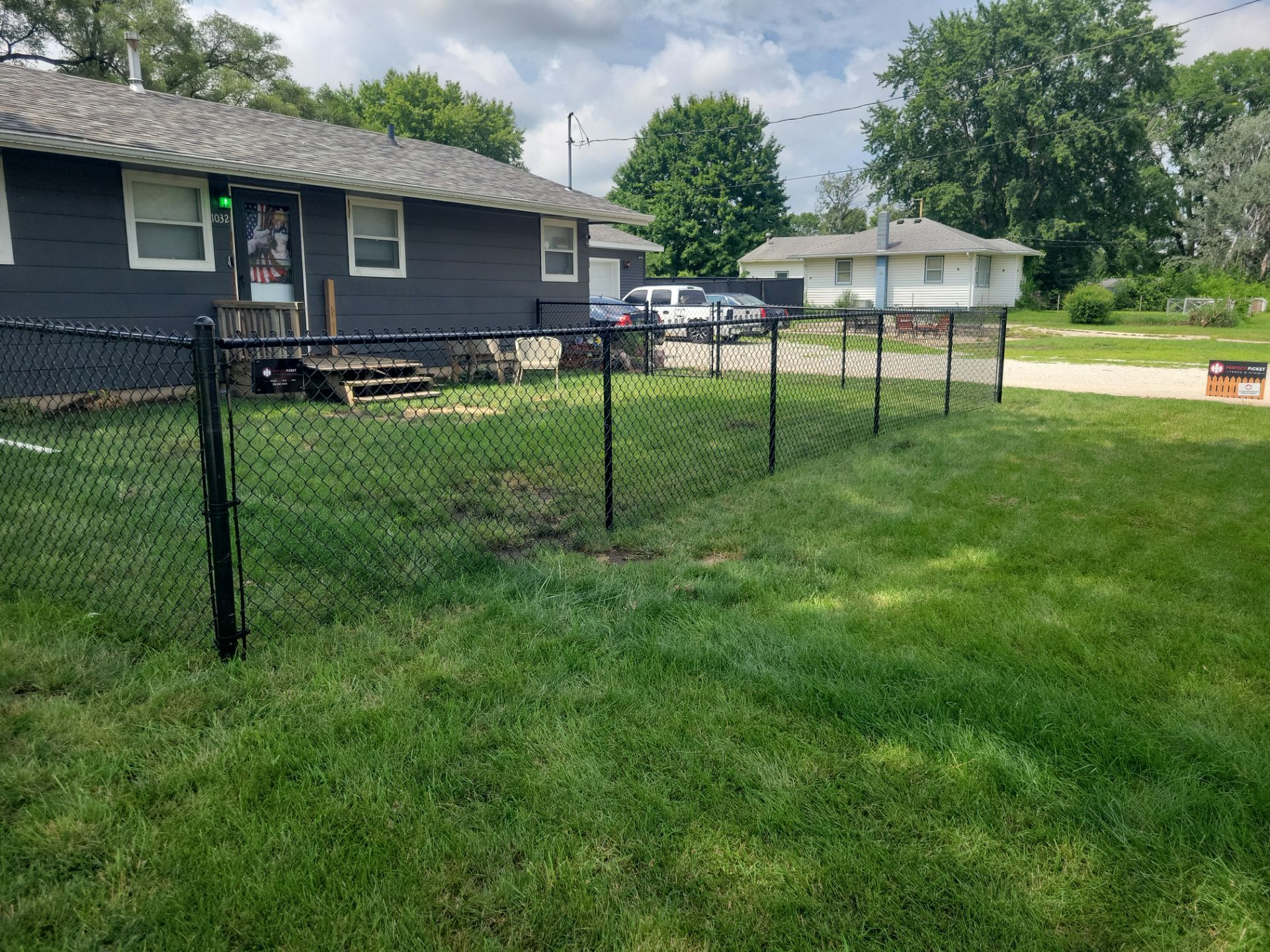 Black Chain Link Perimeter Fence Installation in Waterloo by Perfect Picket Fence and Stain