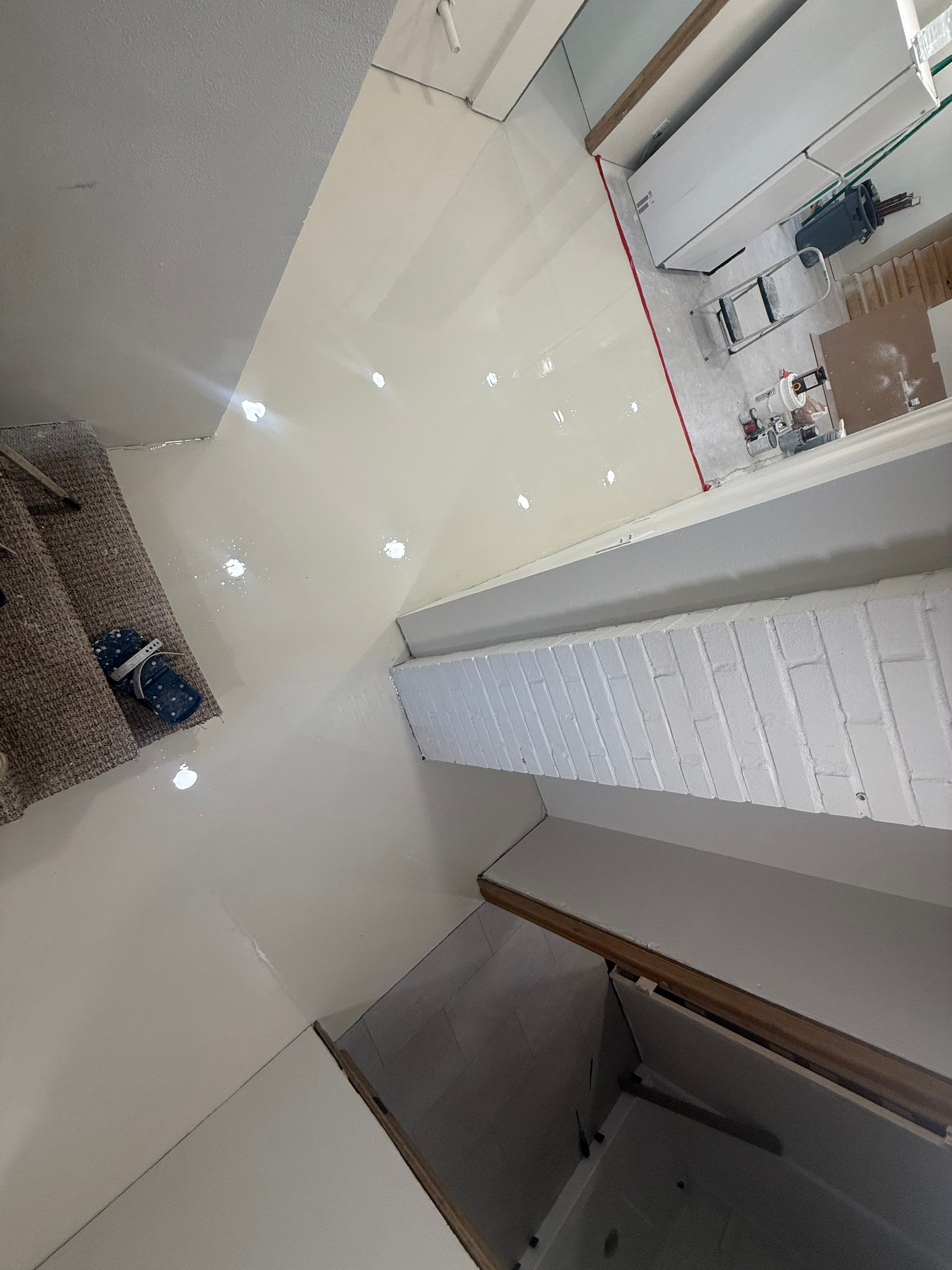 High-Gloss Epoxy Floor Coating and Basement Renovation in Rock Rapids by Select Painting, Coatings & Garage Cabinets