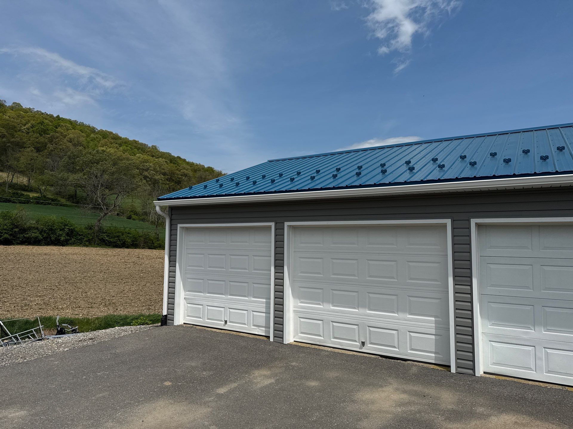 3-Car Garage refresh Blue Metal Roofing in Herndon by Esh Builders