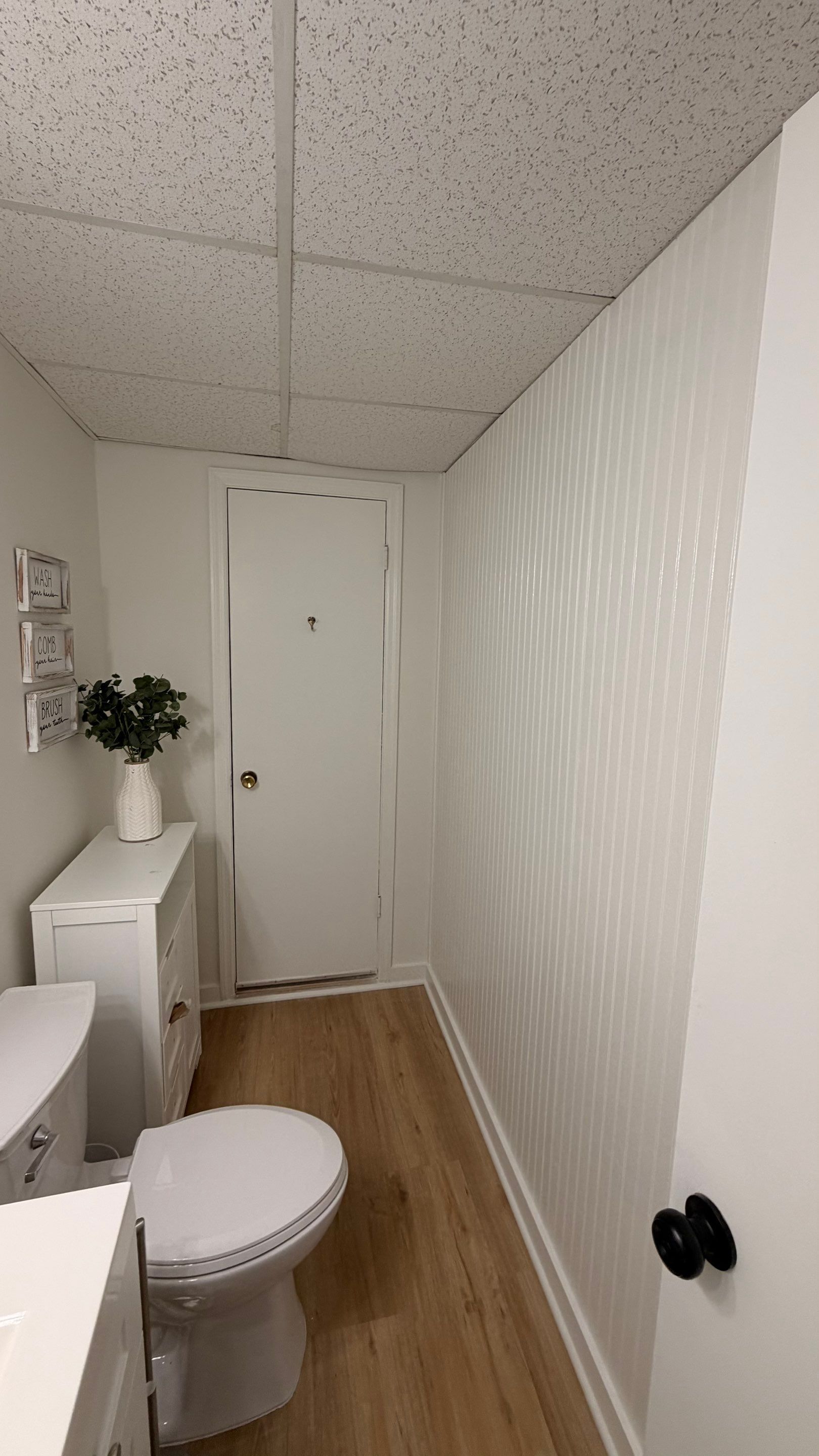 Basement Remodeling with Wood-Look Flooring and Custom Wainscoting in Dunwoody by Swift Home Renovations