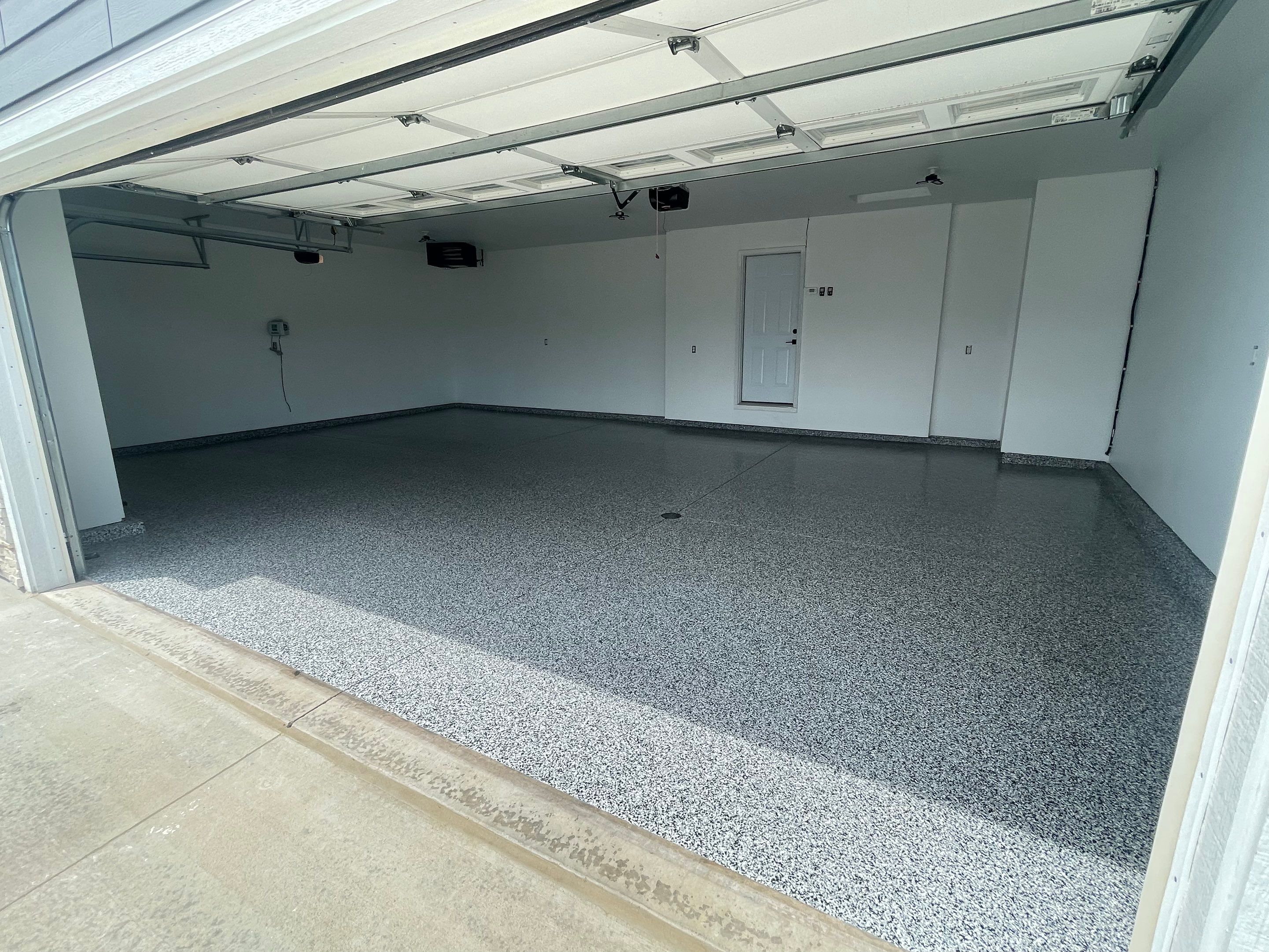Grey Flake Epoxy Garage Floor Coating in Sioux Falls by Select Painting, Coatings & Garage Cabinets