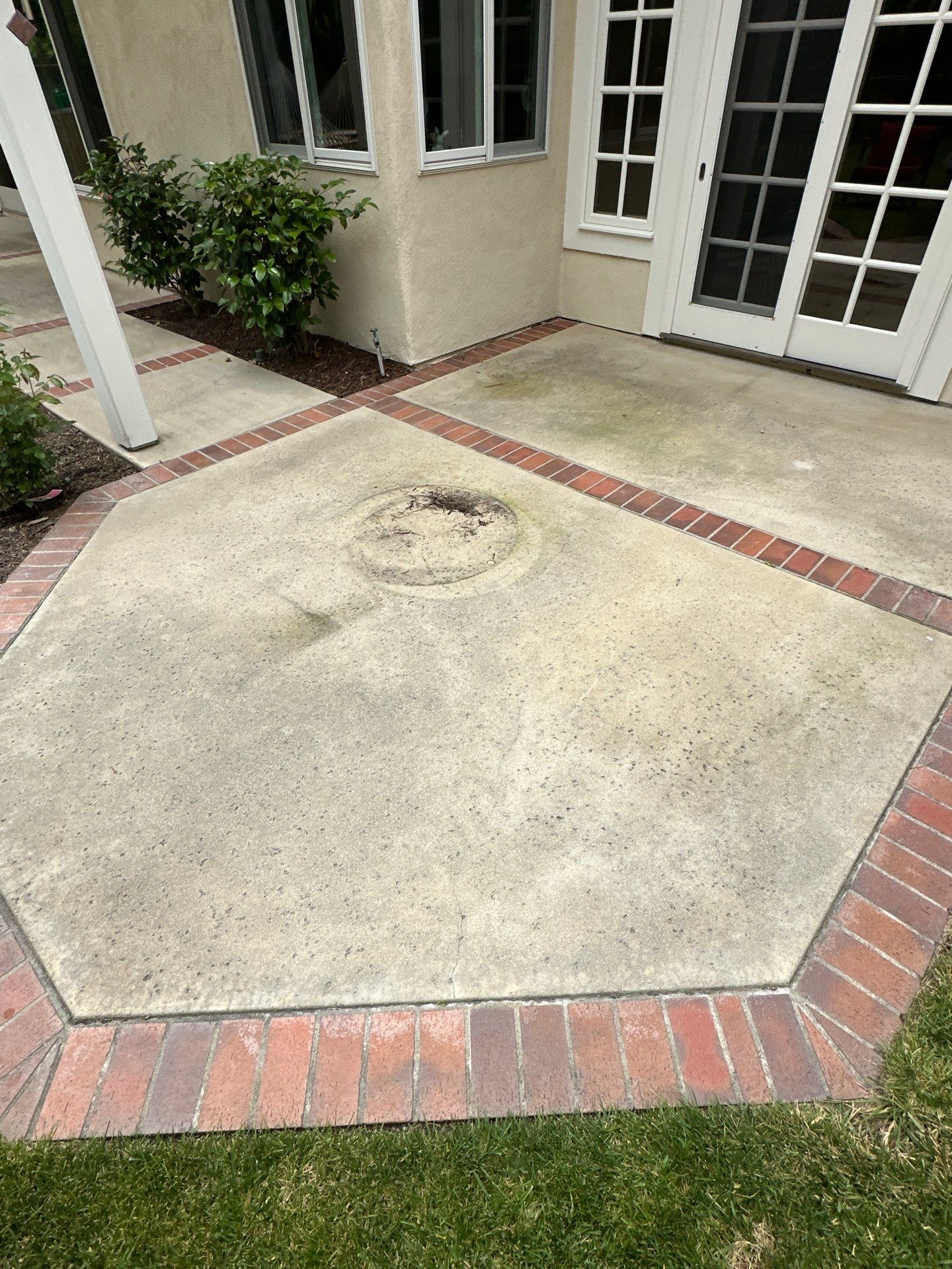 Surface cleaning pressure washing in Orange County on patio, walkways, and driveway by Property Cleaning Experts, LLC