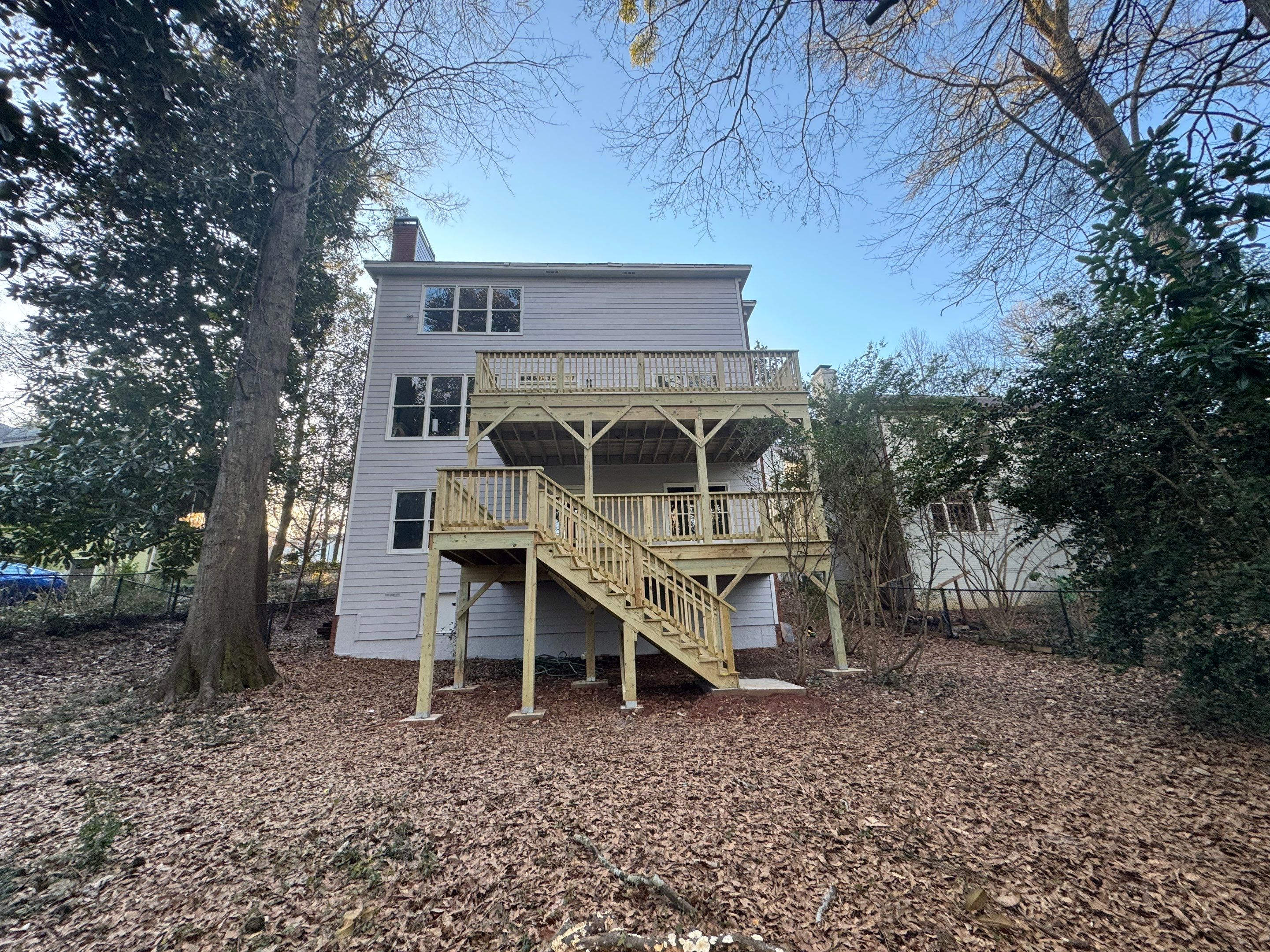 Multi-Level Pressure-Treated Wooden Deck Construction in Decatur by Swift Home Renovations