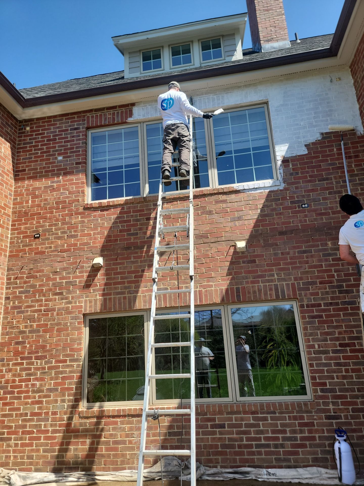Residential Exterior Brick Painting and Limewash Refresh in Sioux Falls by Select Painting, Coatings & Garage Cabinets