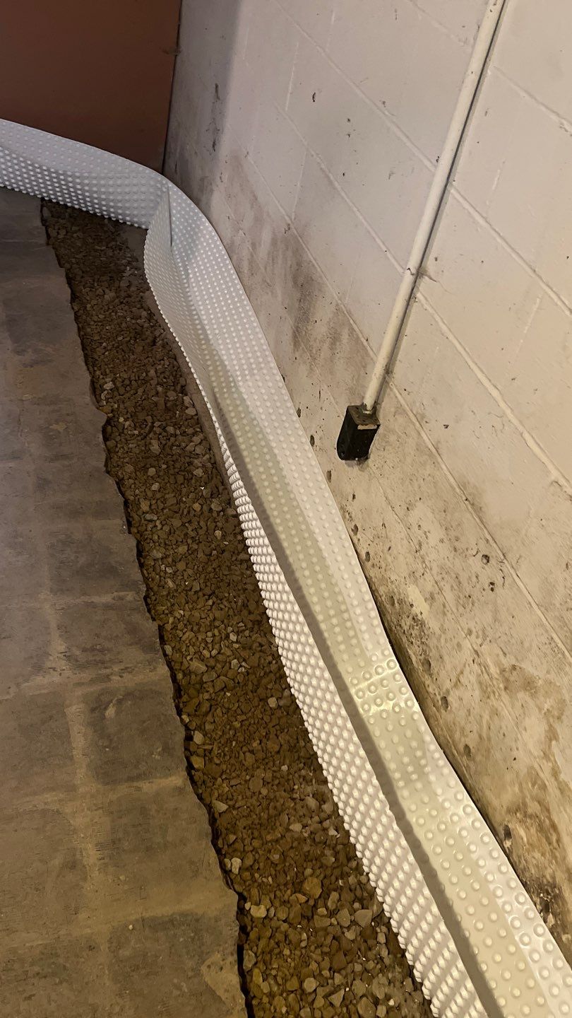 Interior drain tile system installation by ACE Waterproofing & Basement Solutions