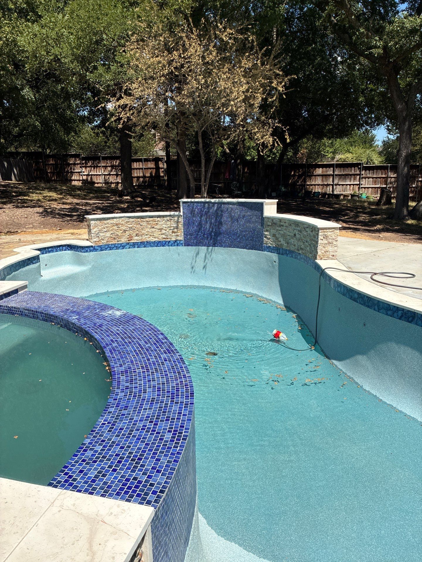 Freeform Pool Remodel with Raised Spa and New Tile by Pinnacle Pools and Spas - DFW