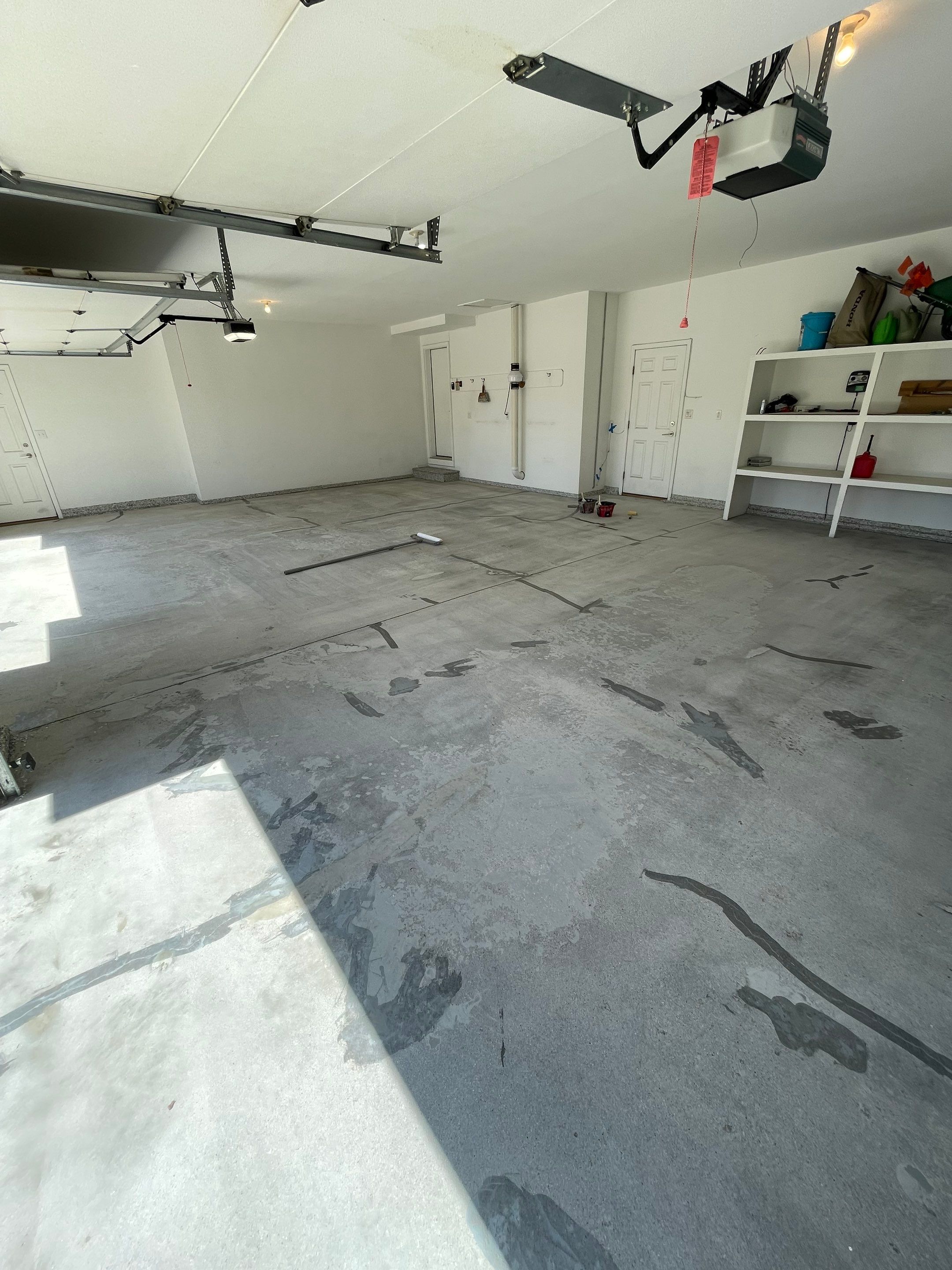 Yankton Garage Floor Restoration with Gray Speckled Epoxy Coating by Select Painting, Coatings & Garage Cabinets