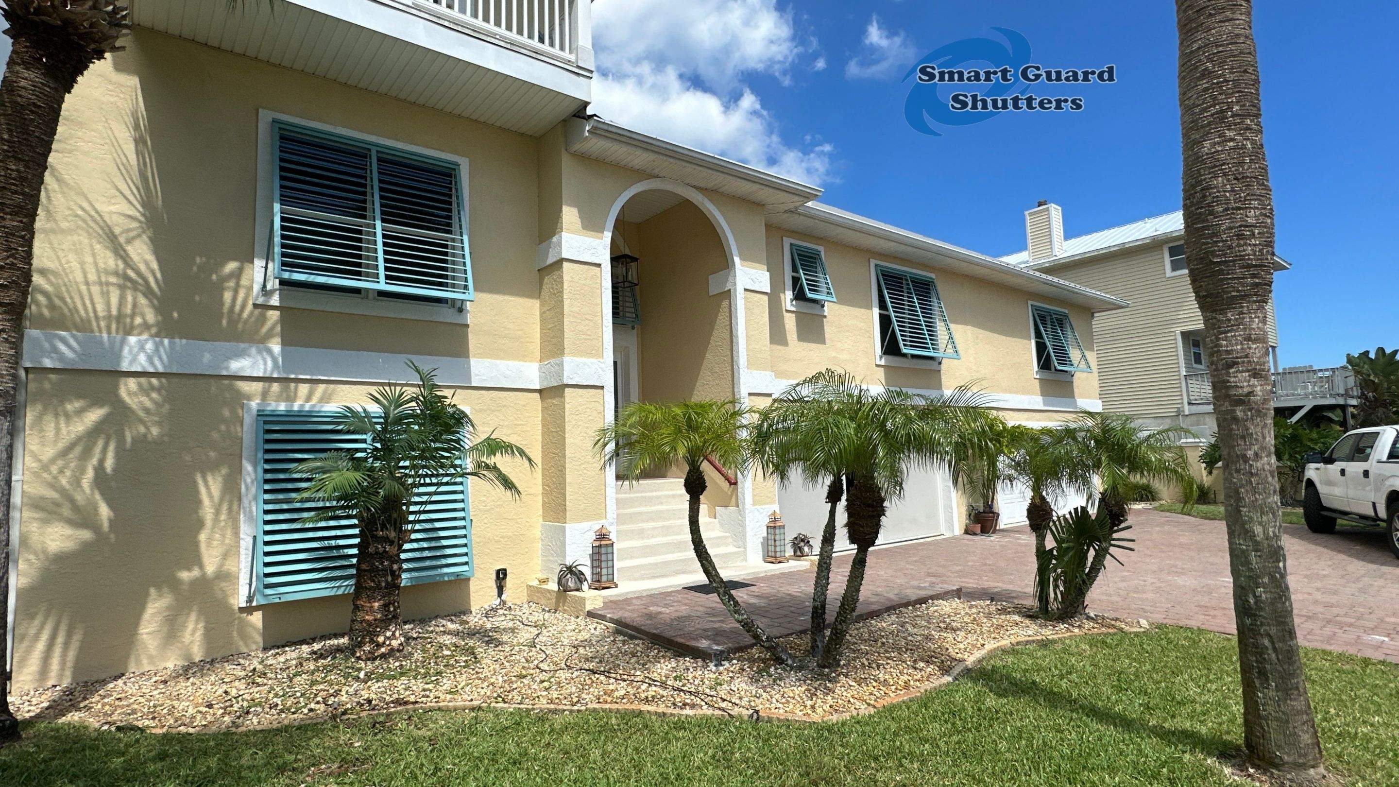Impact Bahama Shutters in Pastel Turquoise by Smart Guard Shutters