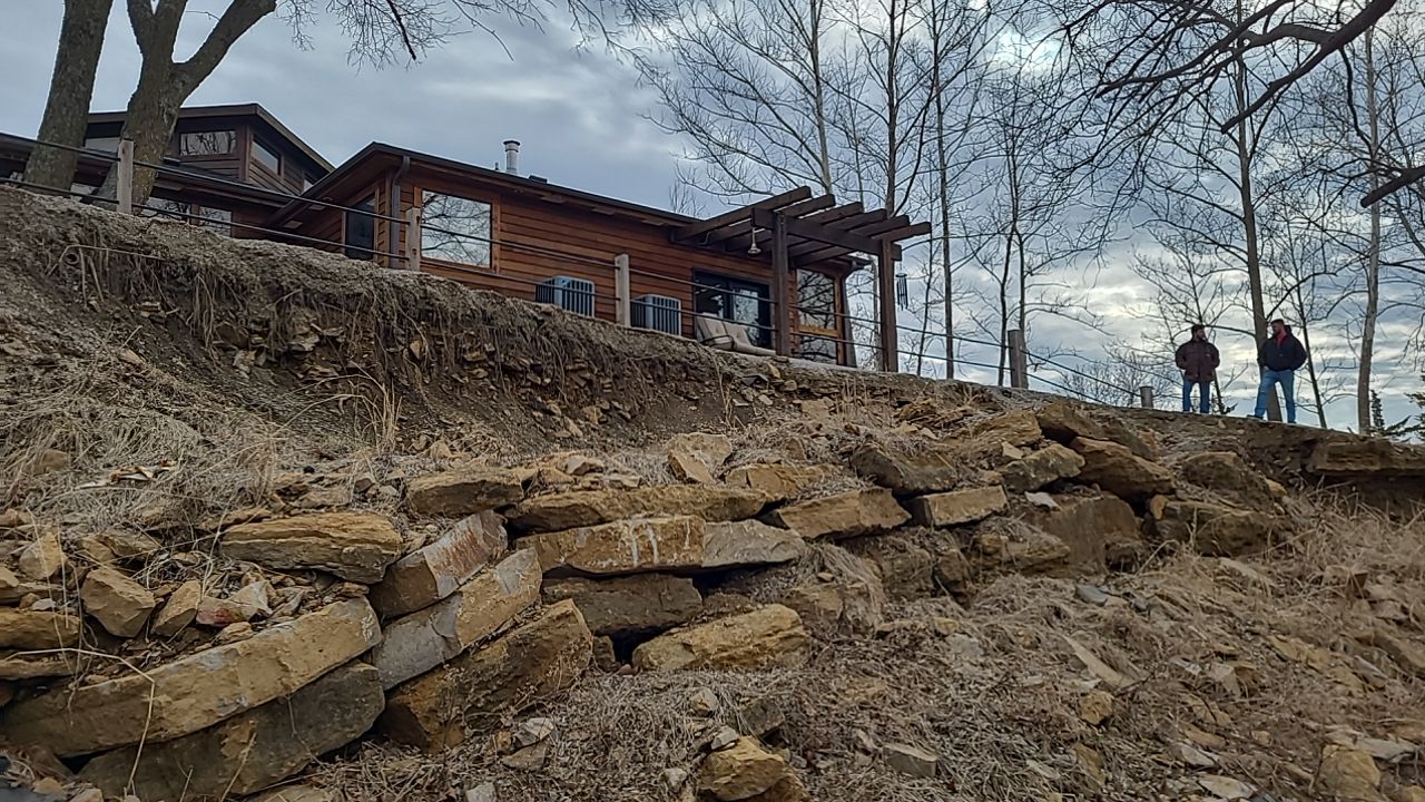 Supporting back of home with backfill at edge of steep creek by LAND ESCAPES LLC