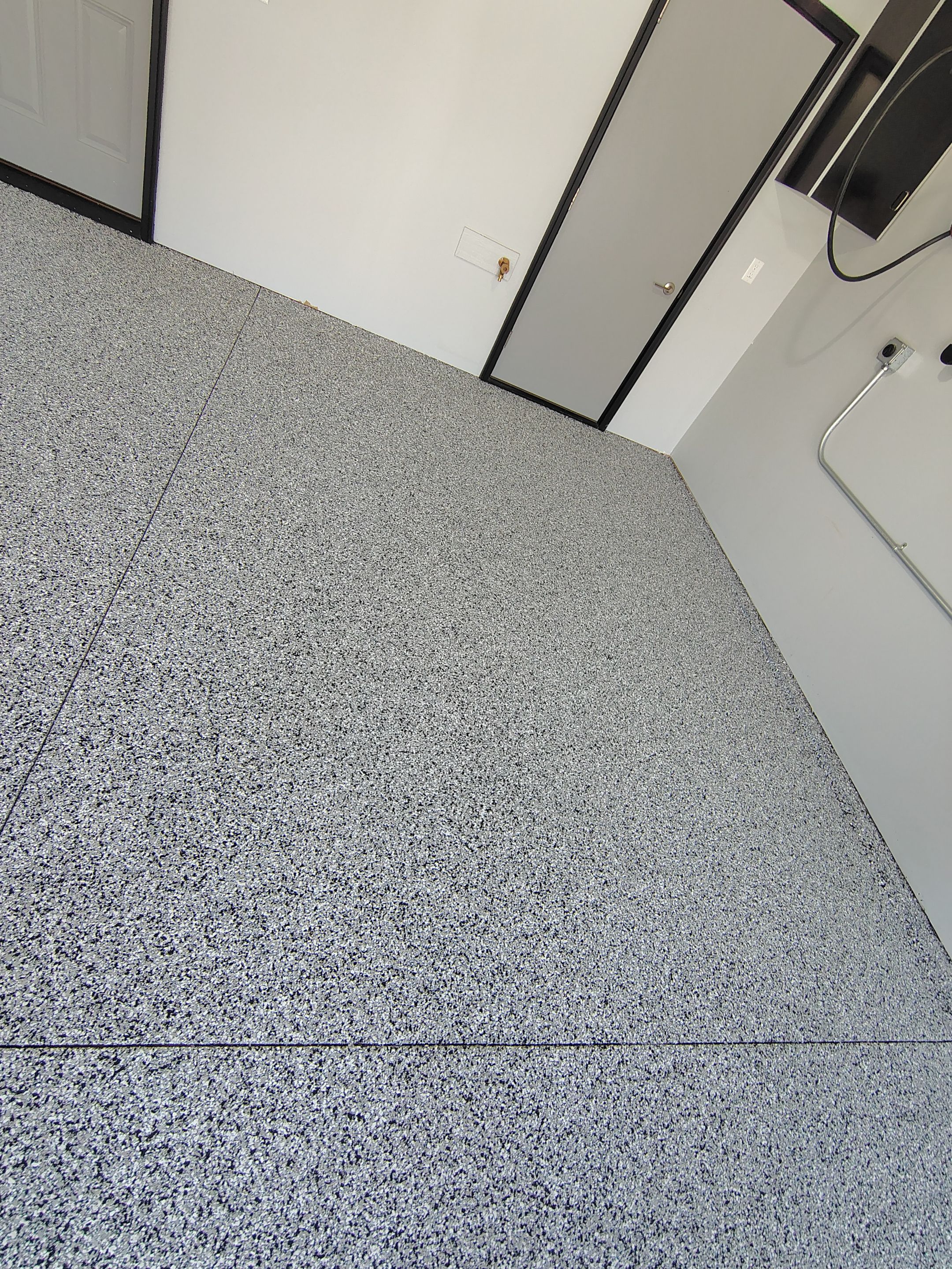 Custom Epoxy Garage Floor Coating Installation in Sioux Falls by Select Painting, Coatings & Garage Cabinets