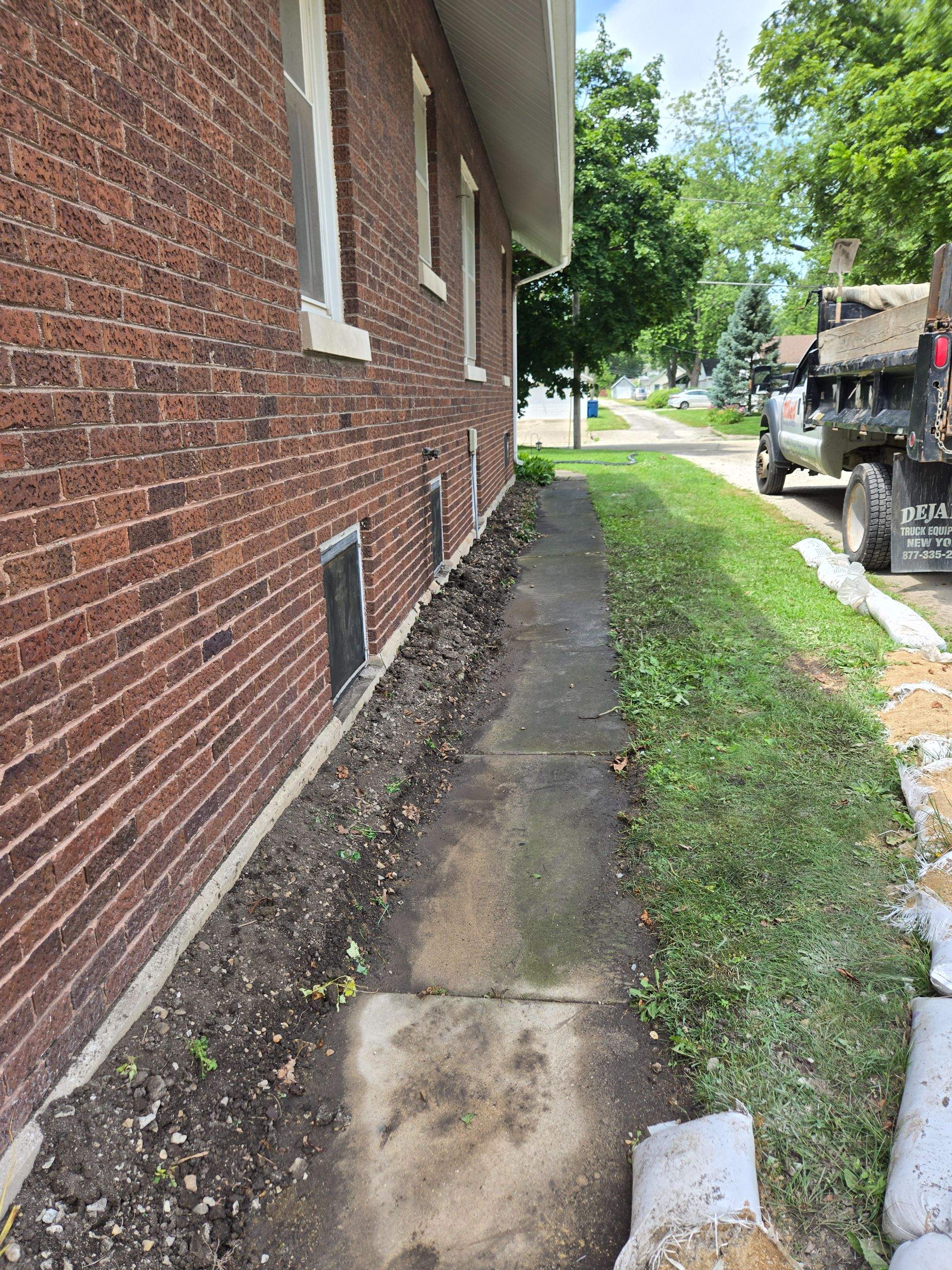 Enhanced Exterior Water Capture Basin With Ultimate Water Drainage French Drain System by Allied Water Services
