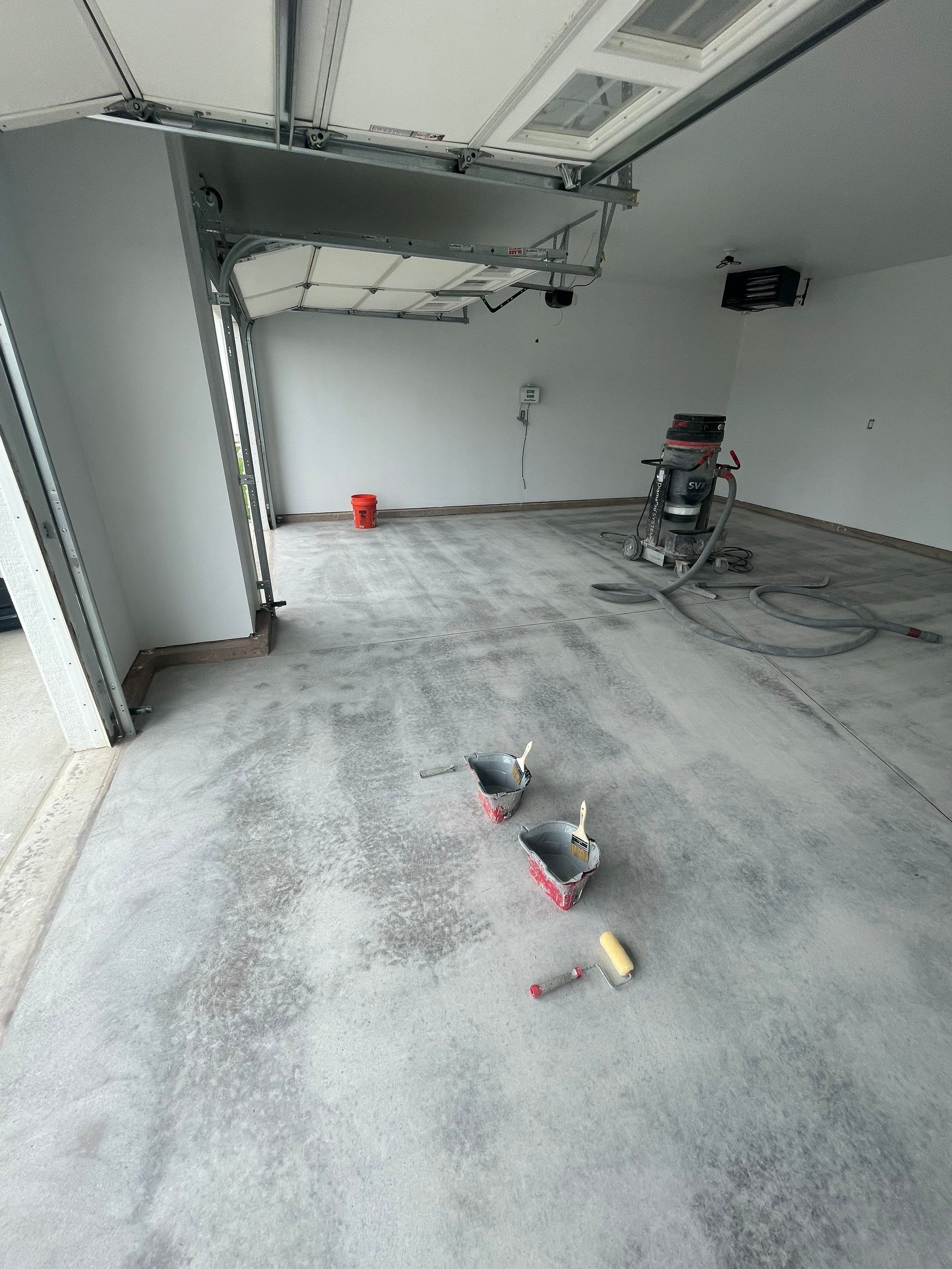 Grey Flake Epoxy Garage Floor Coating in Sioux Falls by Select Painting, Coatings & Garage Cabinets