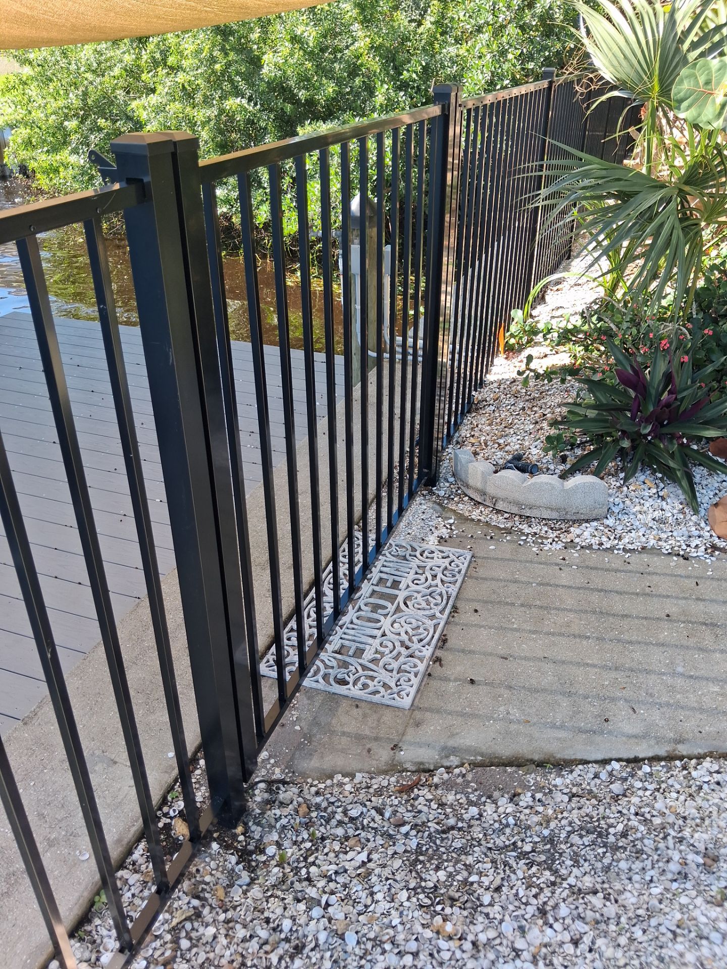 Black Aluminum Picket Fence Installation for Port Charlotte Canal Home by True Fence LLC