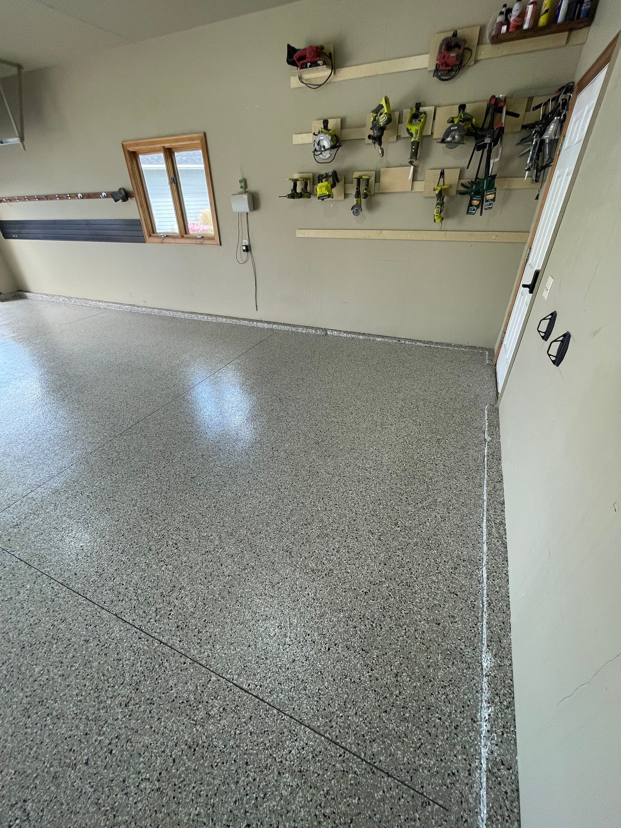Cabin FEver Flake Garage Floor Coating Installation in Sioux Falls by Select Painting, Coatings & Garage Cabinets
