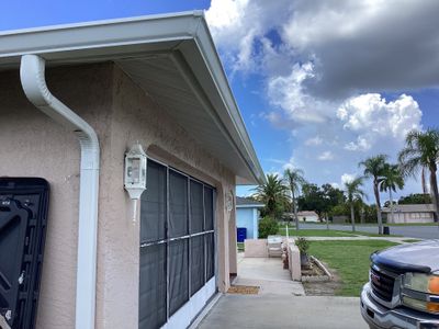 White Seamless Gutters and Splash Guards in Fort Myers FL by Gutter Professor