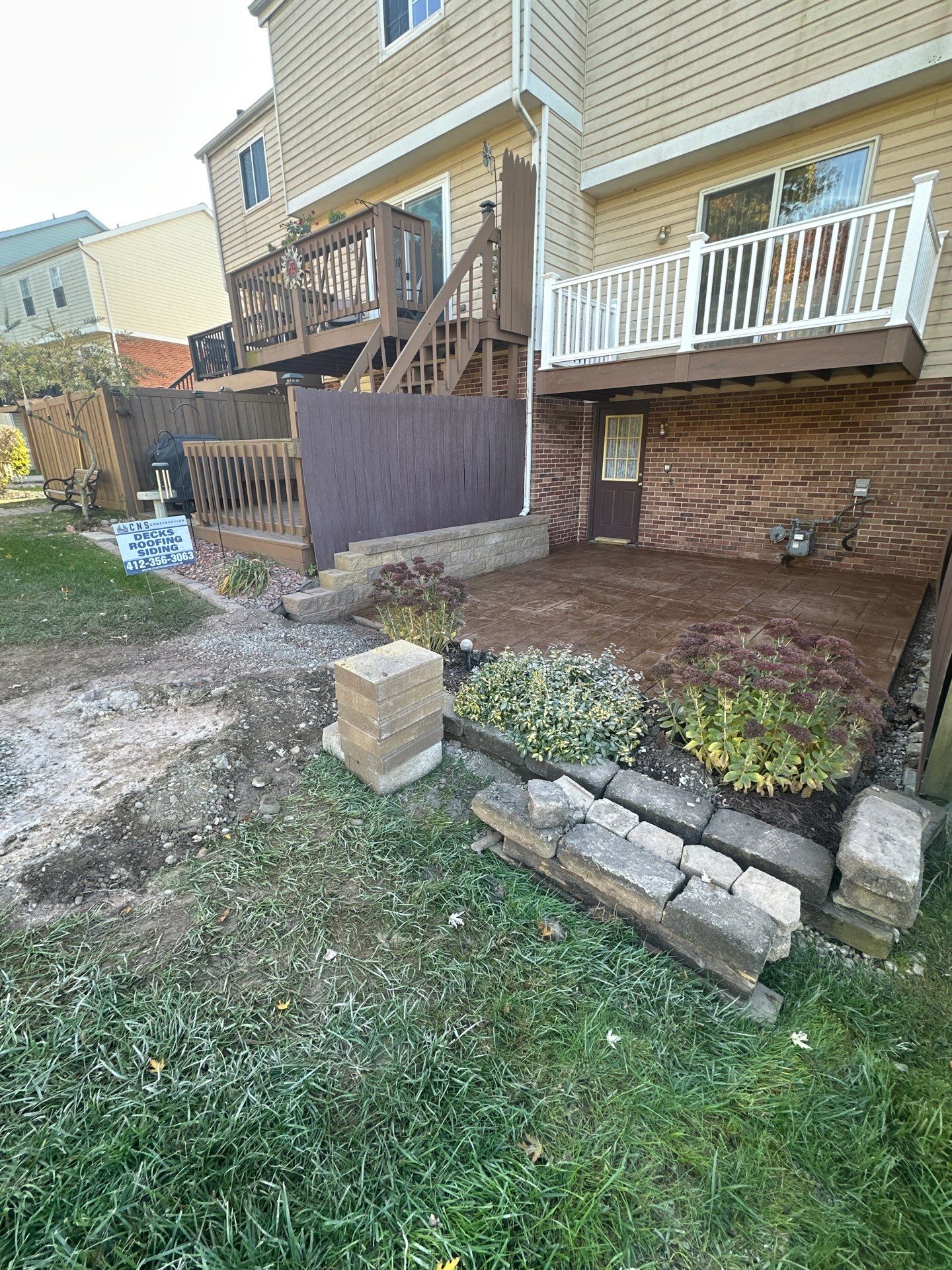 Stamped concrete and redeck  by Cousins Roofing Siding & Decks