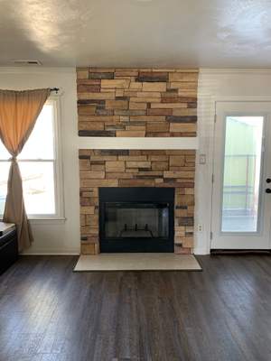 Wood fireplace + stone + mantel