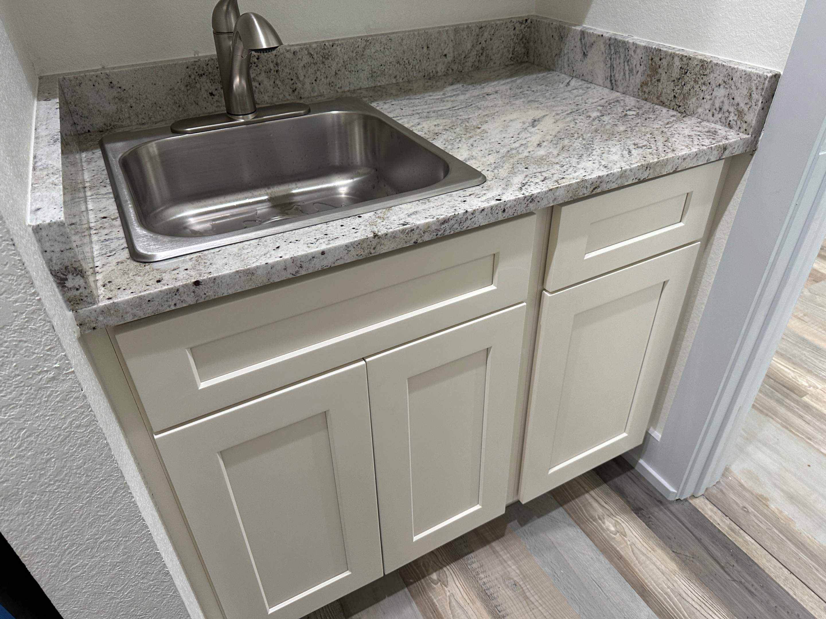 Antique shaker cabinets and granite kitchen and bathroom installation by Mena stone surfaces