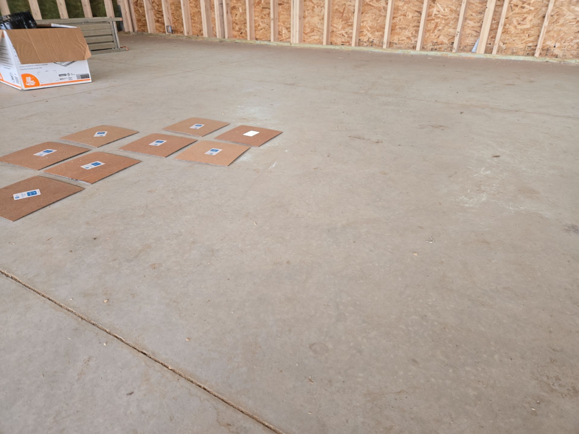 Speckled Epoxy Floor Coating for Large Shop in Rock Valley by Select Painting, Coatings & Garage Cabinets