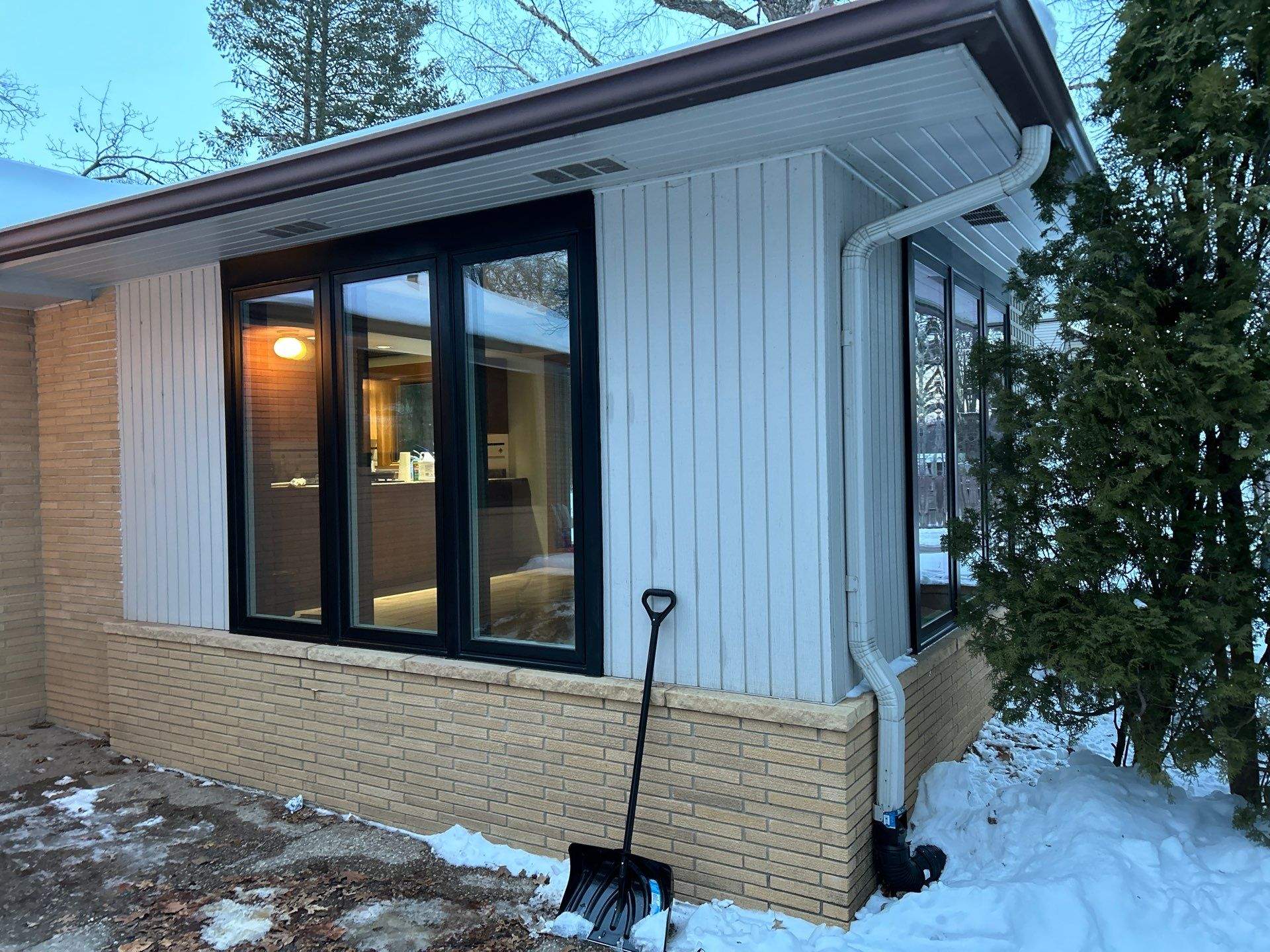 Black-Frame Pella Lifestyle Upgrade on a Partial Brick Home by United Windows and Siding LLC