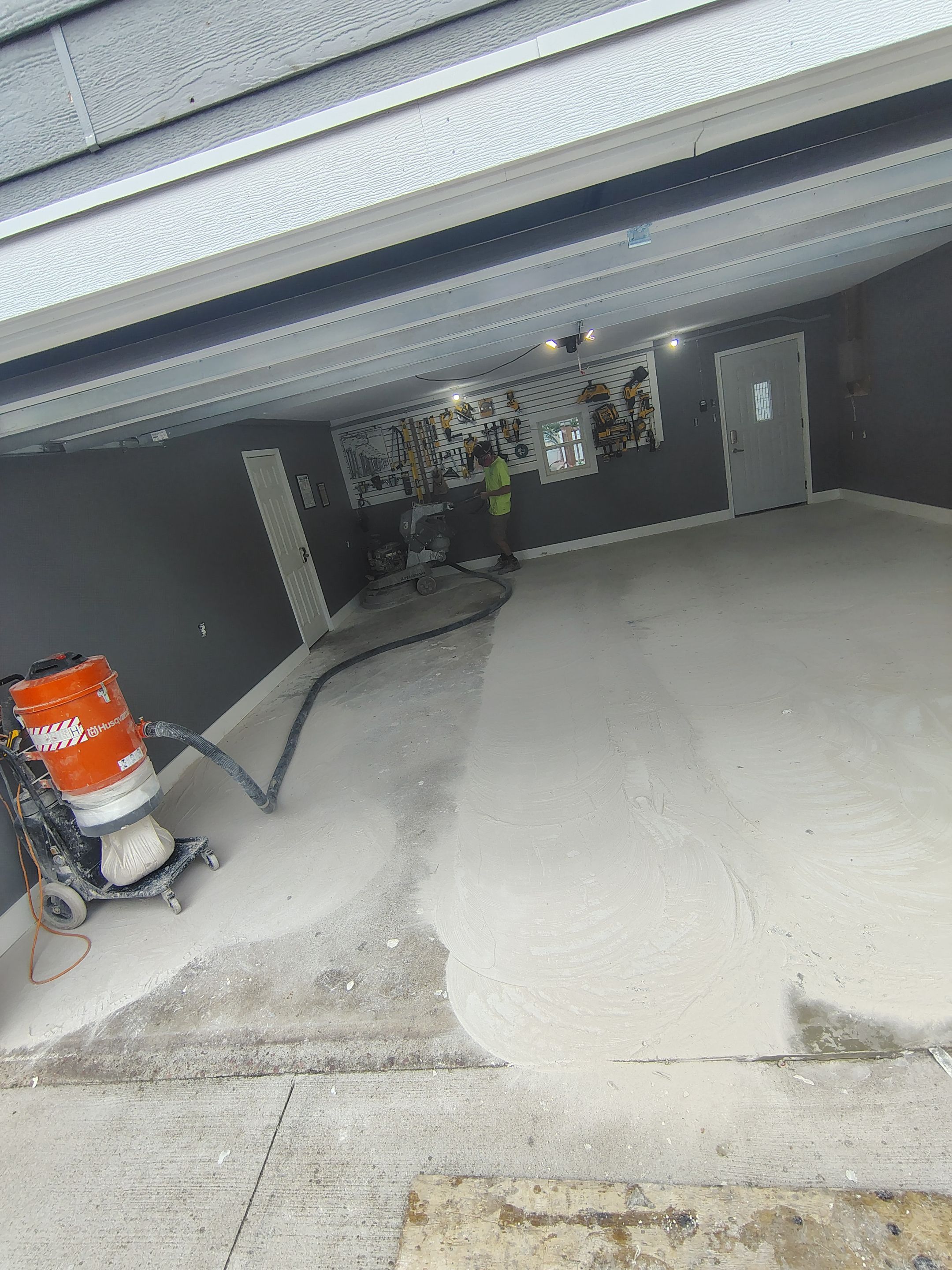 Custom Garage Floor Coating and Backyard Patio Refinishing in Tyndall by Select Painting, Coatings & Garage Cabinets