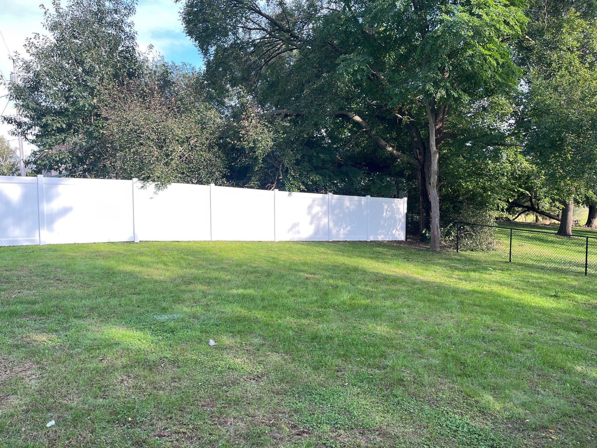 White Vinyl Privacy Fence and Black Chain Link Installation in Sumner by Perfect Picket Fence and Stain