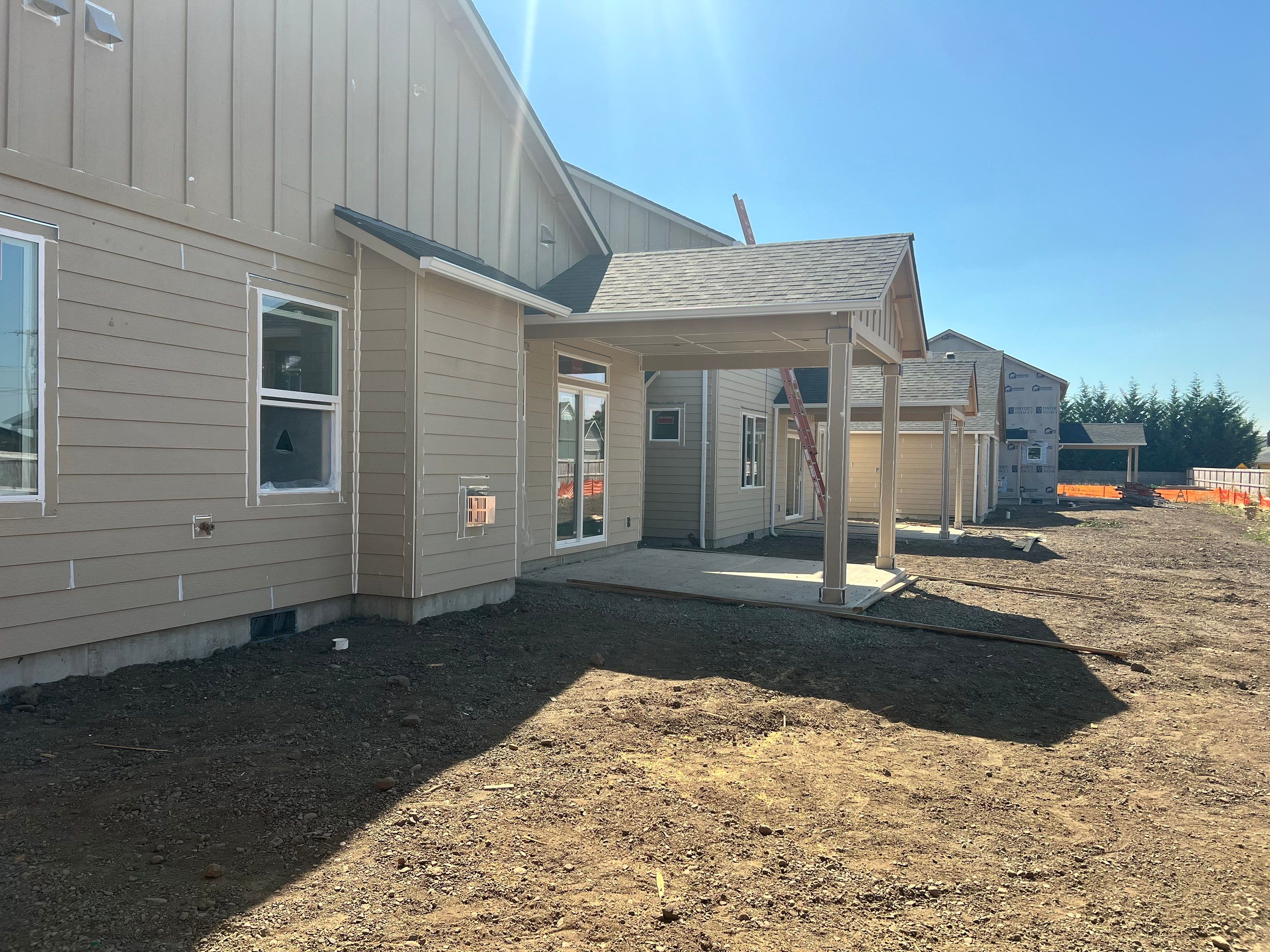 Continuous White Gutter and Downspout Installation for New Eugene Home by BEST Roofing & Waterproofing