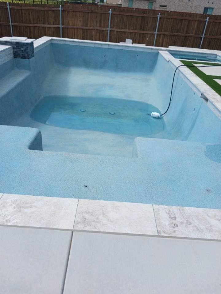 Geometric Pool with Tanning Ledge and Turf Accents by Pinnacle Pools and Spas - DFW