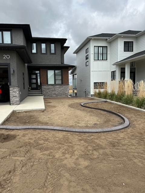 Decorative Concrete Curbing and River Rock Landscape Installation by Pump it Up Concrete Jacking