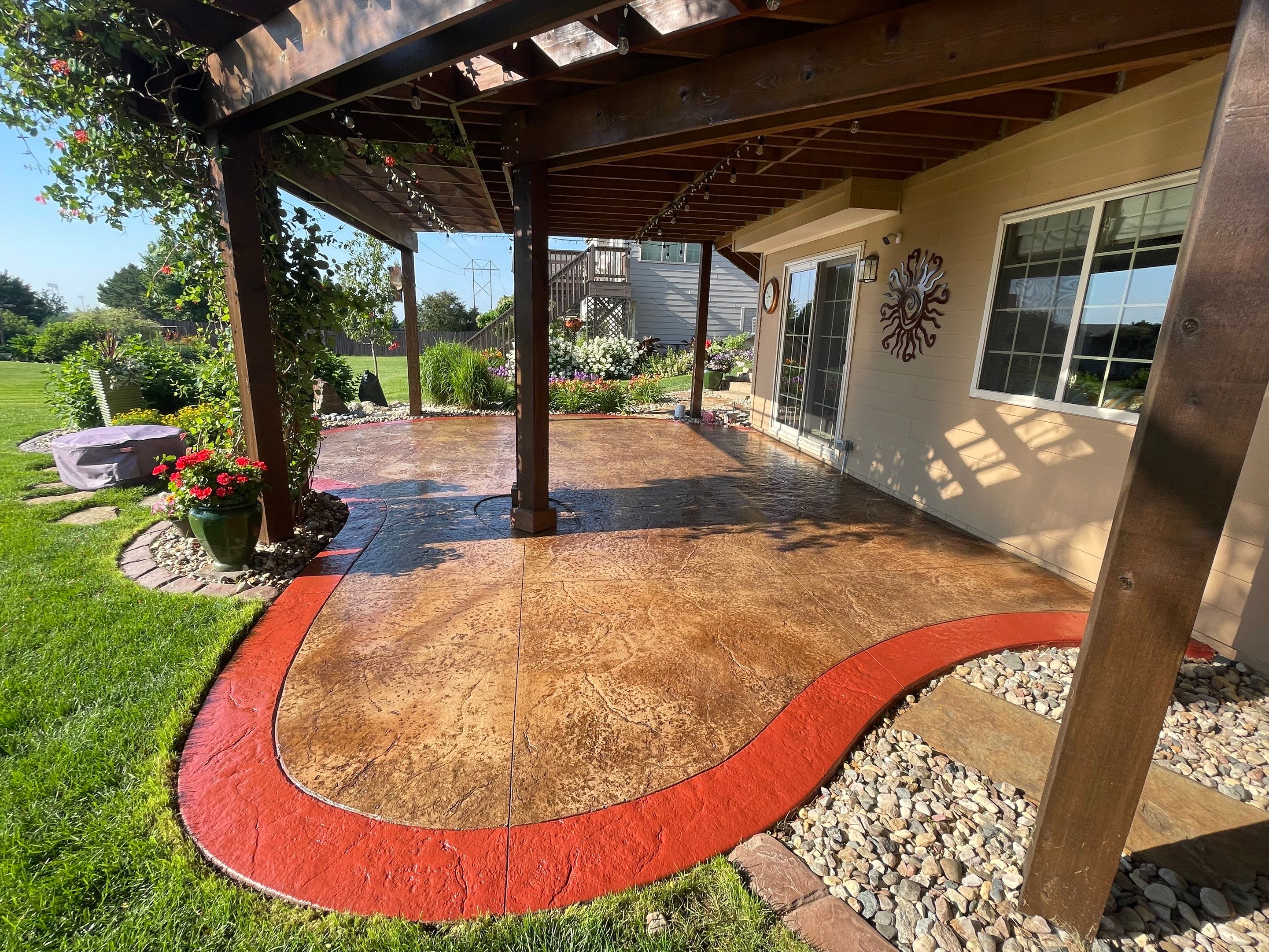 Custom Stamped Concrete Patio and Wood Pergola in Sioux Falls by Select Painting, Coatings & Garage Cabinets