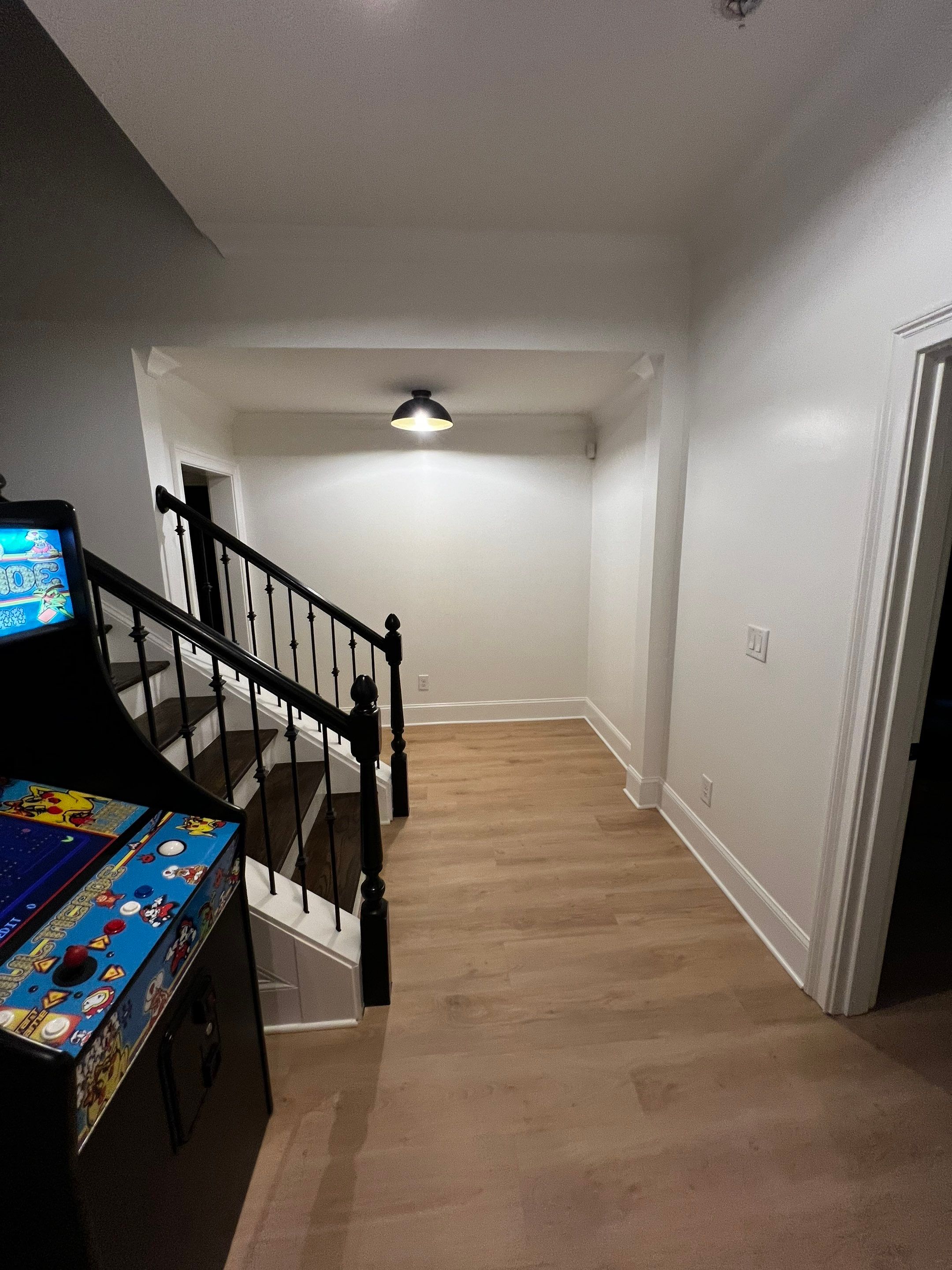 Atlanta Basement Refinishing with Wood Laminate Flooring and Interior Painting by Swift Home Renovations